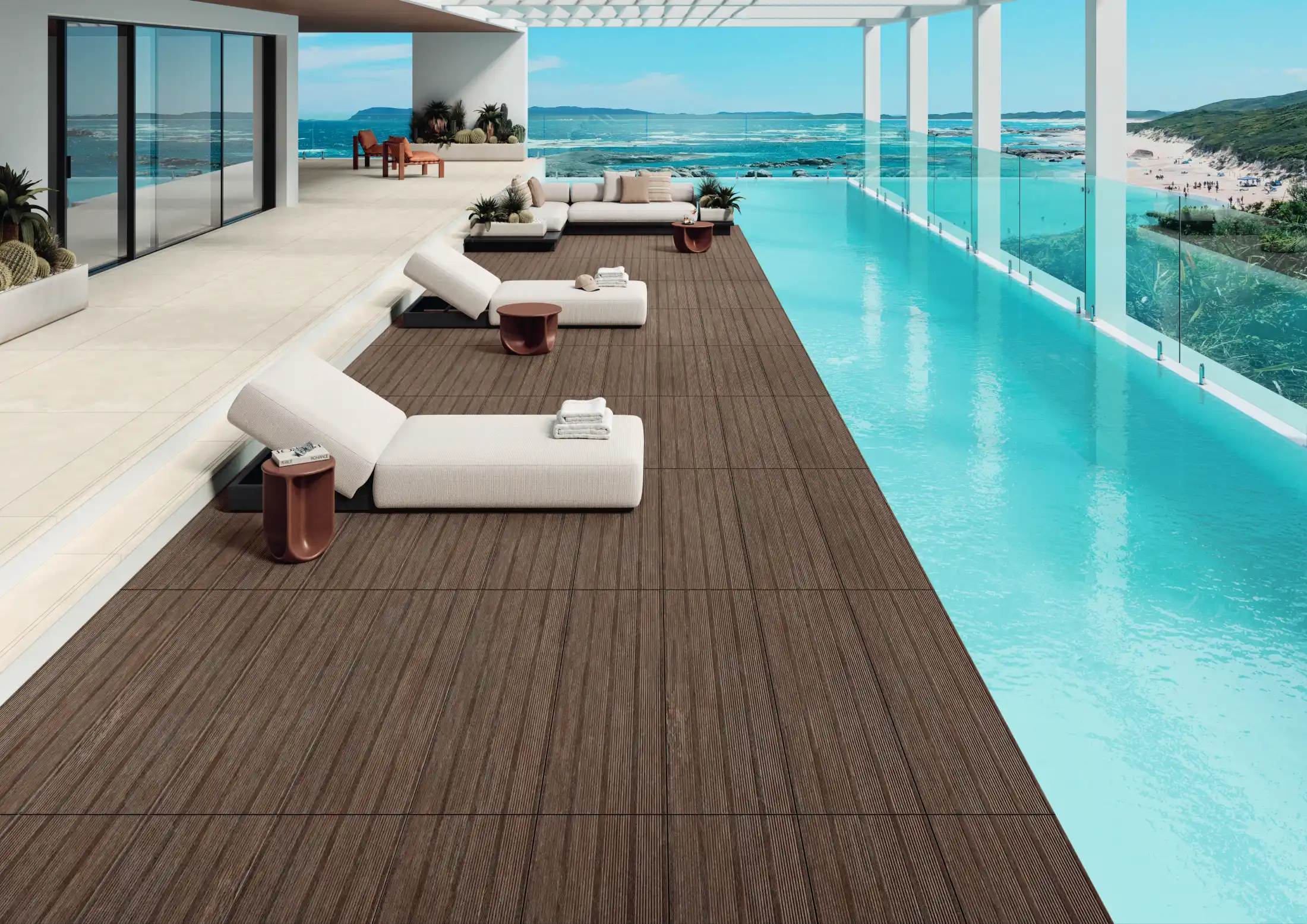 Modern poolside deck with light brown outdoor lounge chairs and tables beside an infinity pool.