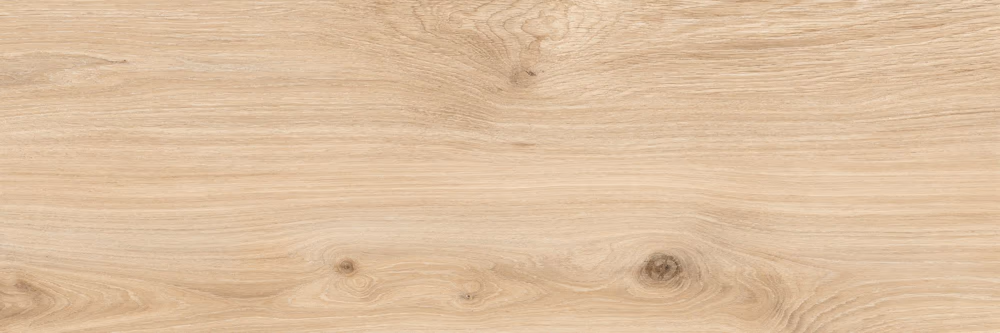 Smooth light wooden surface with natural grain and knots visible.