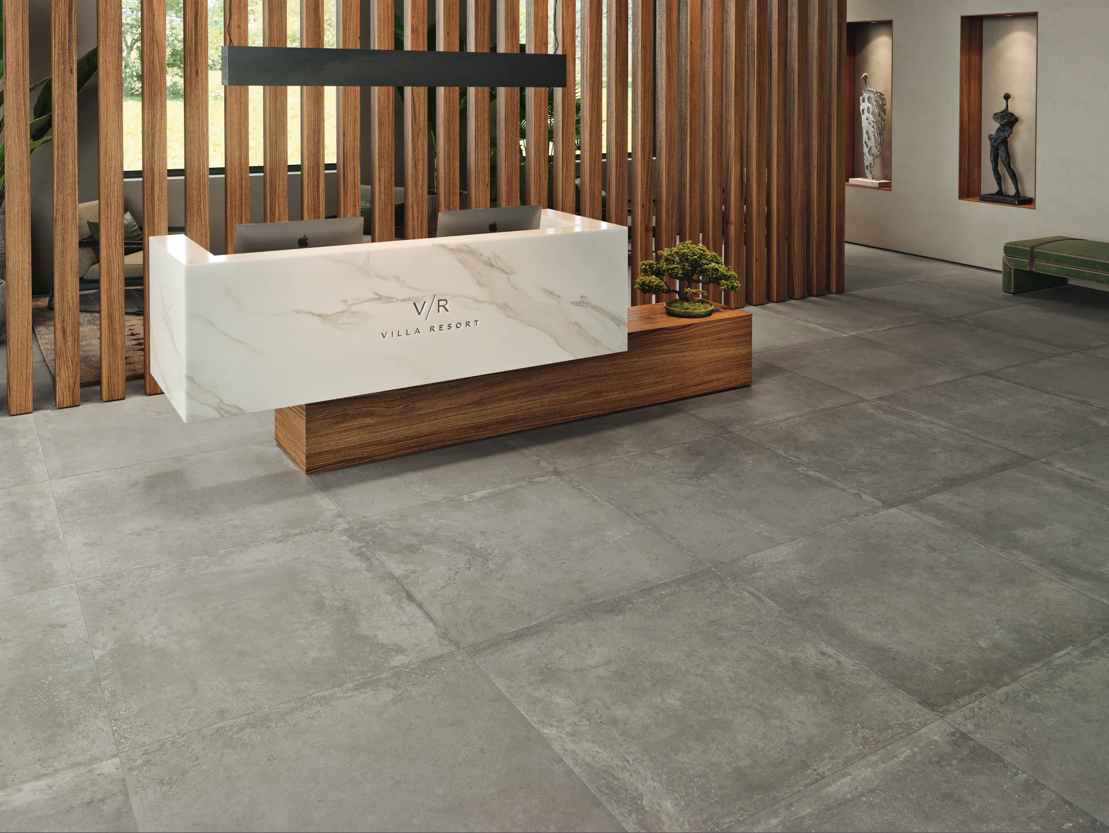 Modern villa resort reception with white marble and wood desk, gray tiled floor, and decorative sculptures.