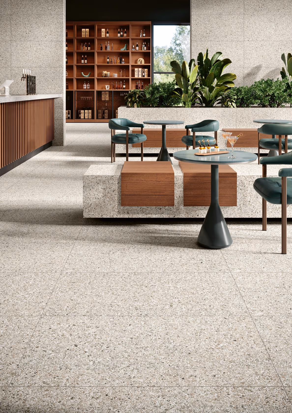 Modern cafe seating with green chairs, round tables, terrazzo flooring, and plants on concrete benches.