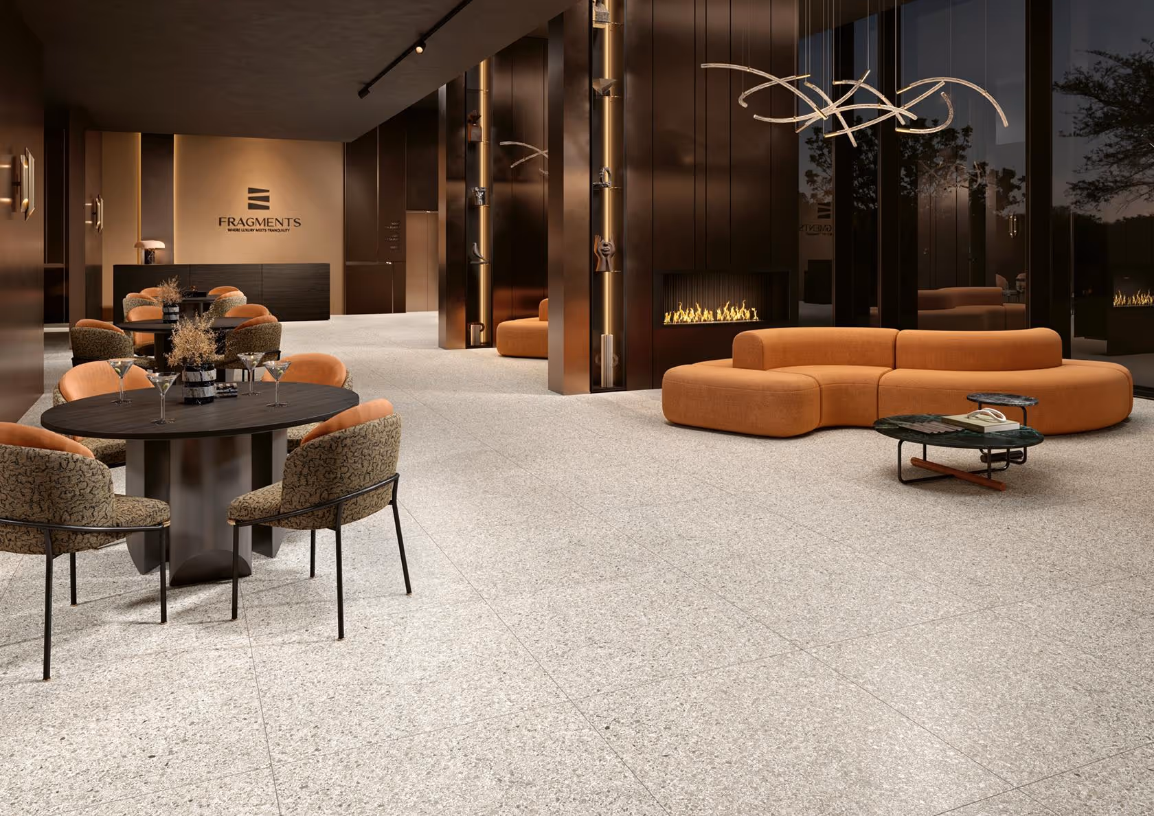 Modern lounge with orange curved sofa, black round tables, patterned chairs, and a sleek fireplace.