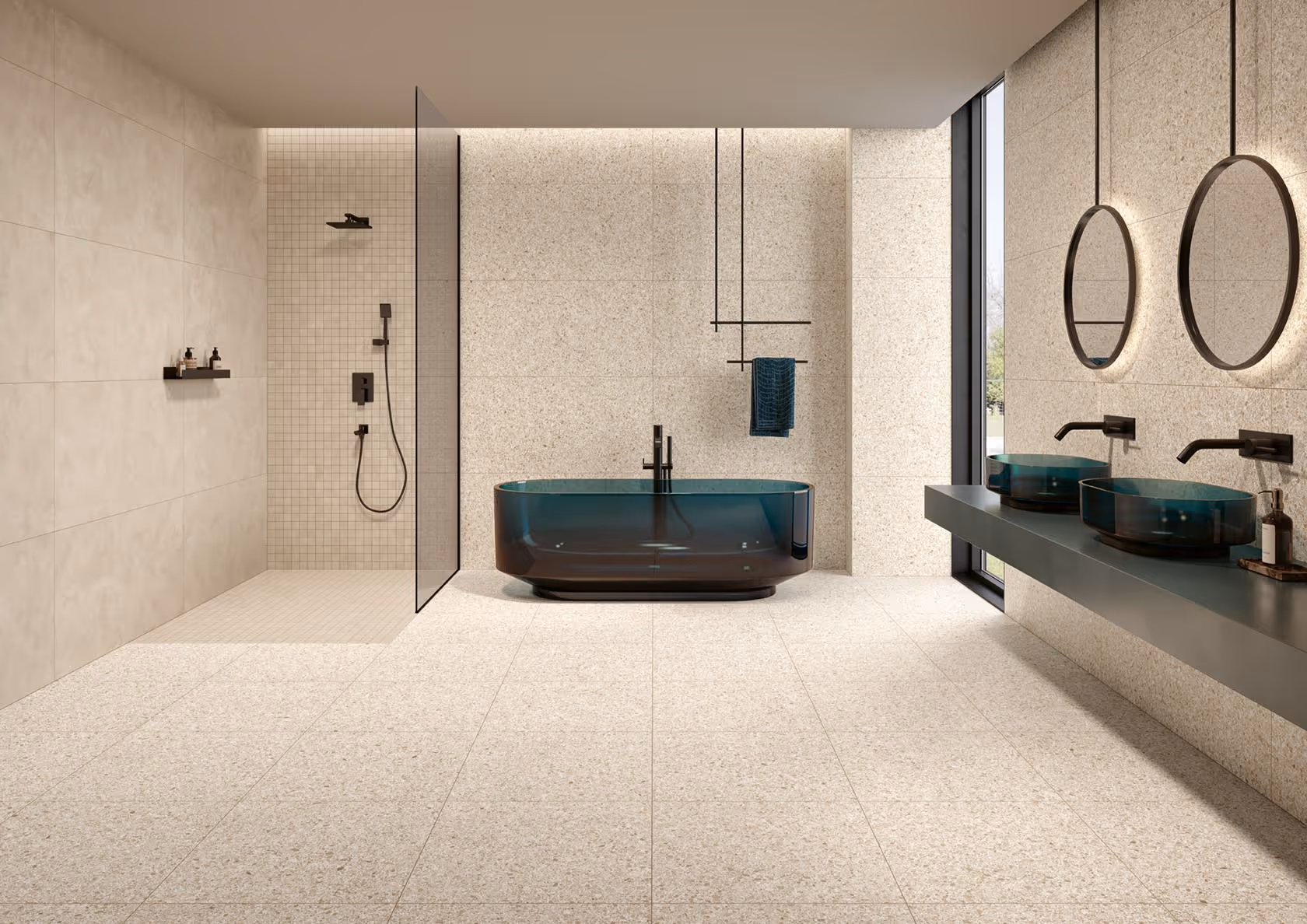 Modern bathroom with a blue bathtub, glass shower, double blue vessel sinks, and round mirrors.
