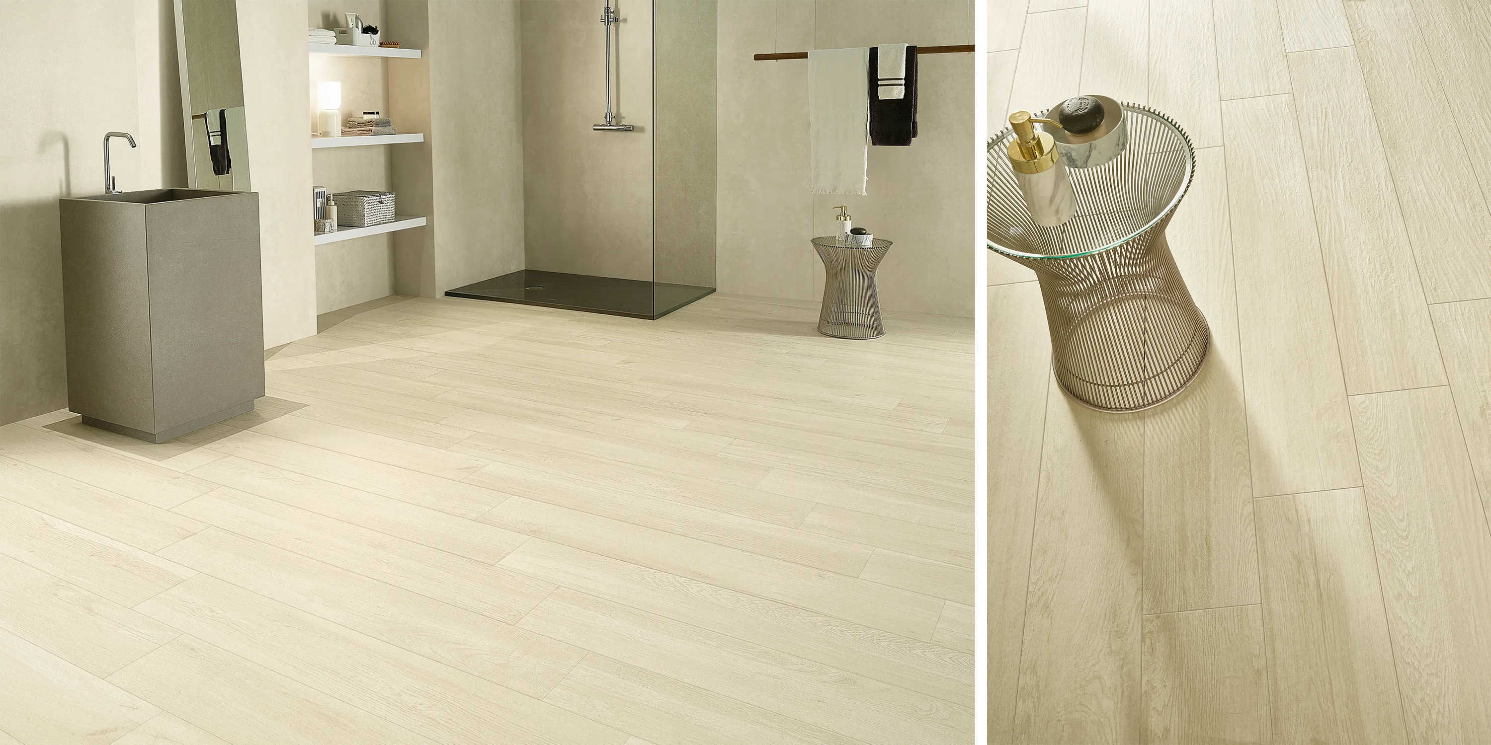 Modern bathroom with light wood-look tile flooring, gray sink, open shower, and wireframe side table.