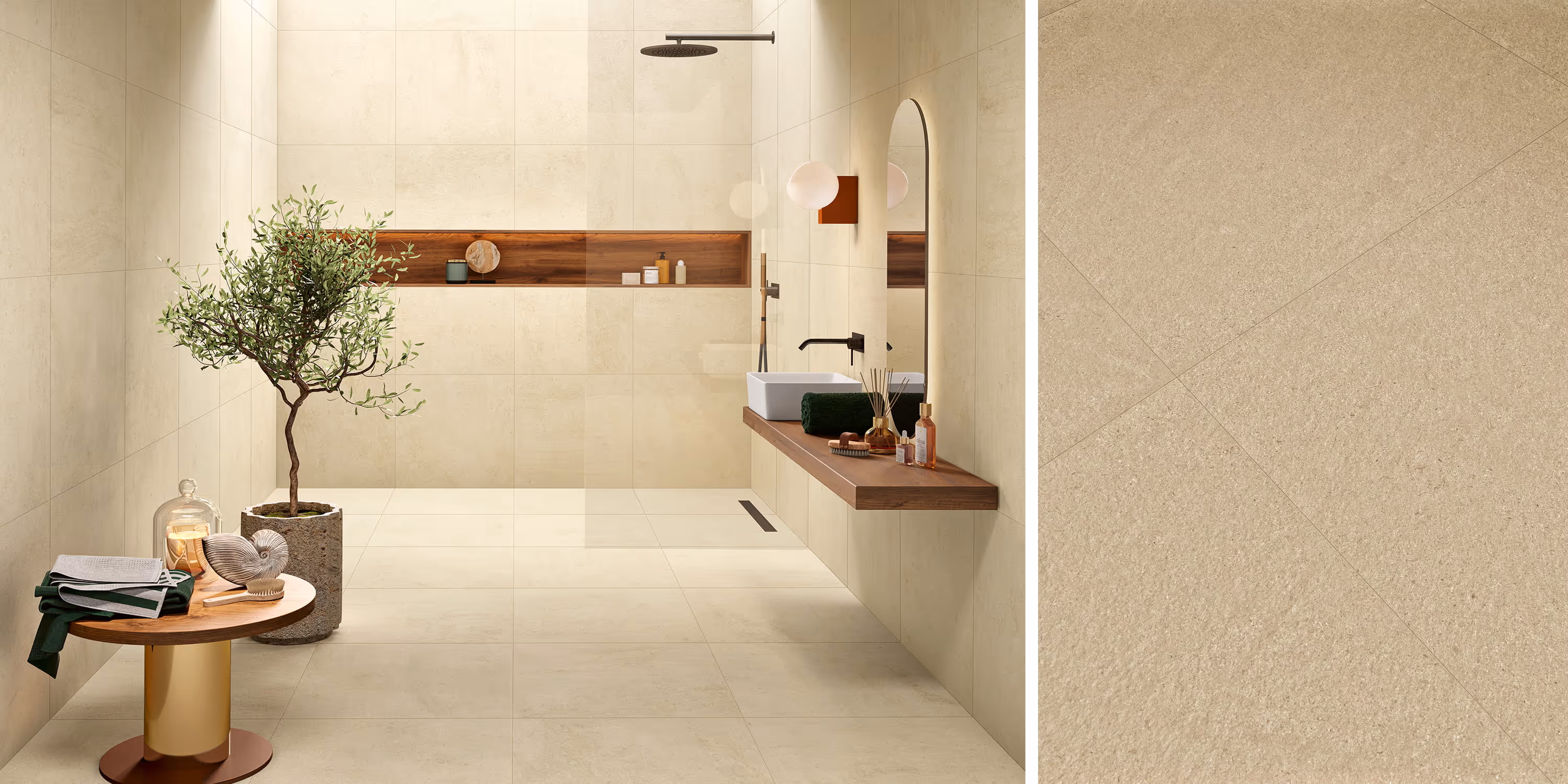 Modern beige tiled bathroom with walk-in shower, wooden floating vanity, table, and green plant.