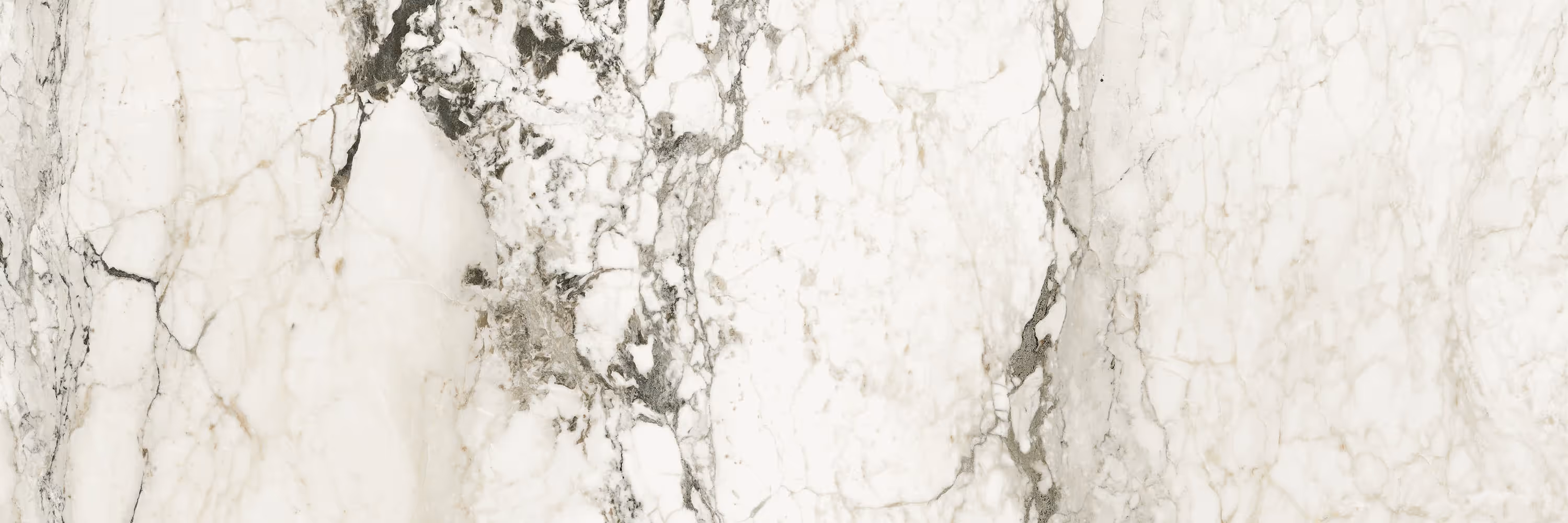White marble surface with gray and black natural veining and patterns.