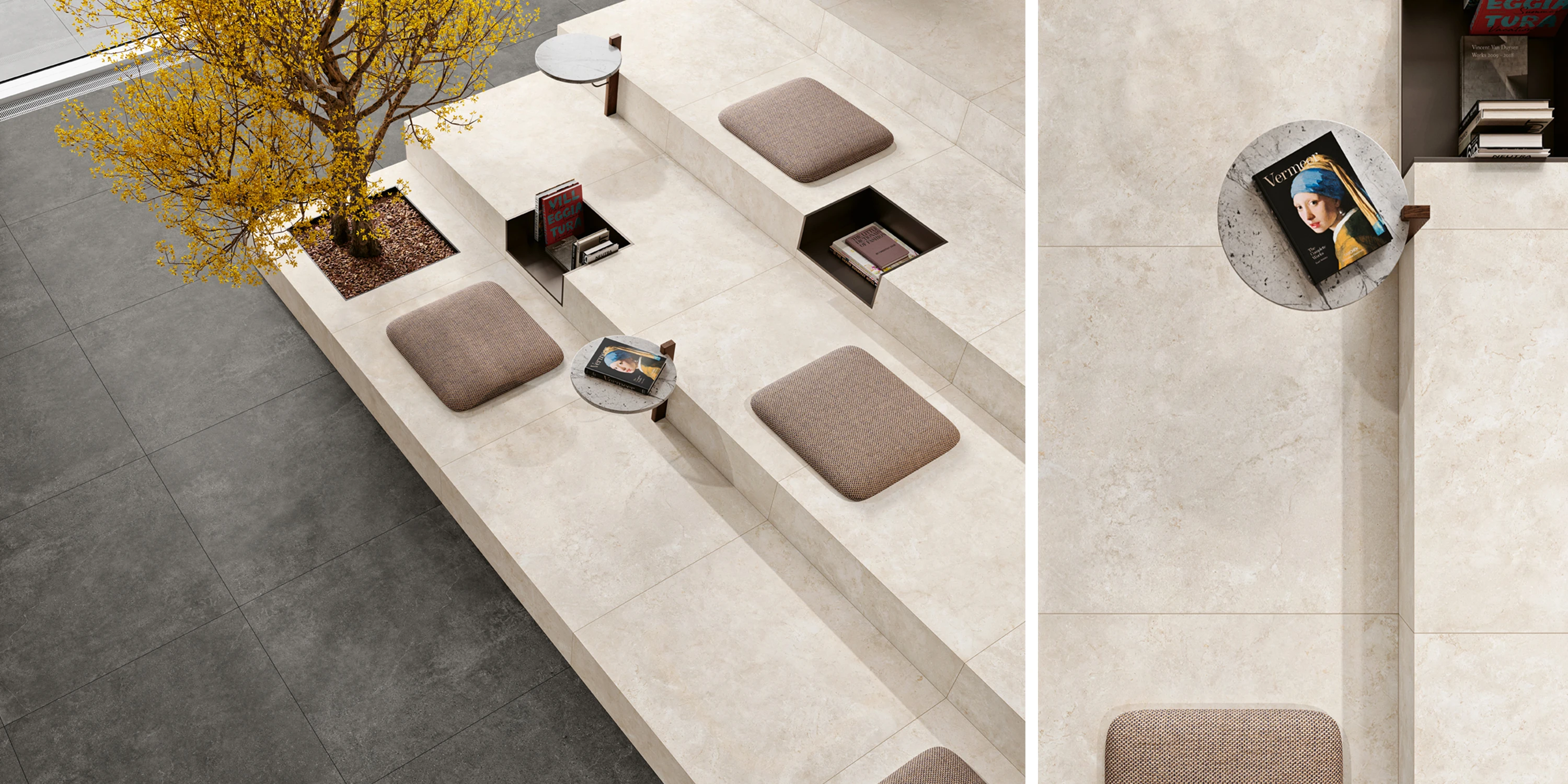 Modern stone seating area with brown cushions, small round tables, built-in book storage, and a tree.