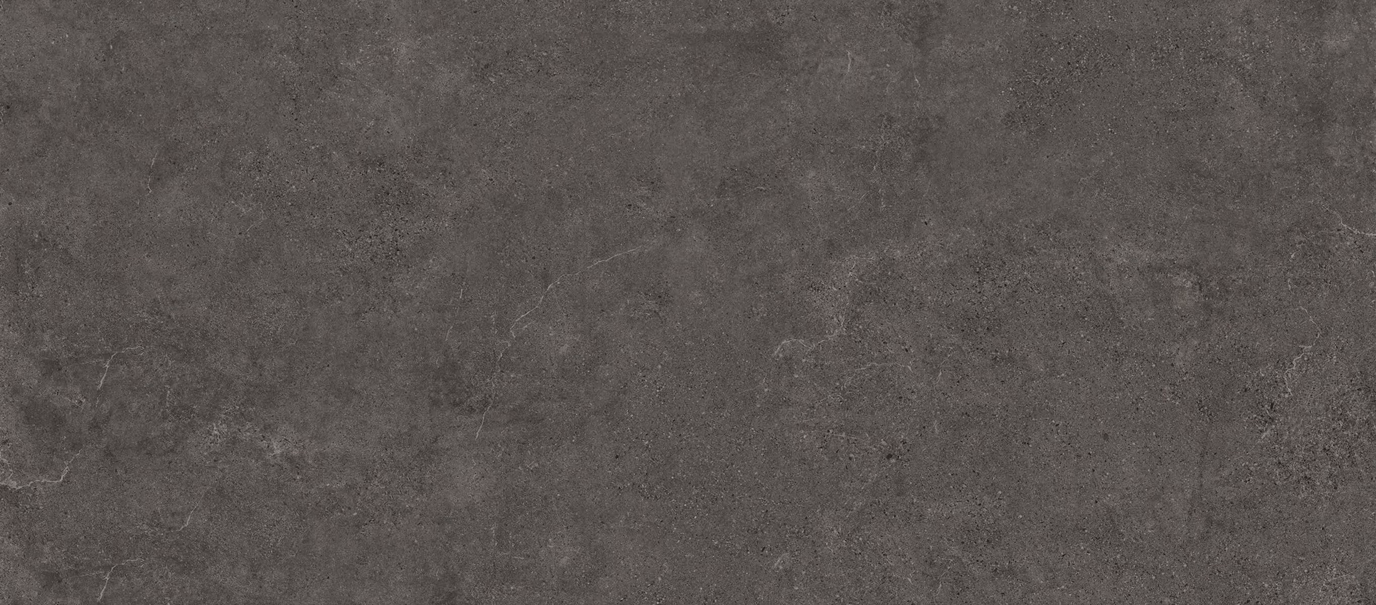 Dark gray textured stone surface with subtle veins and speckled patterns.