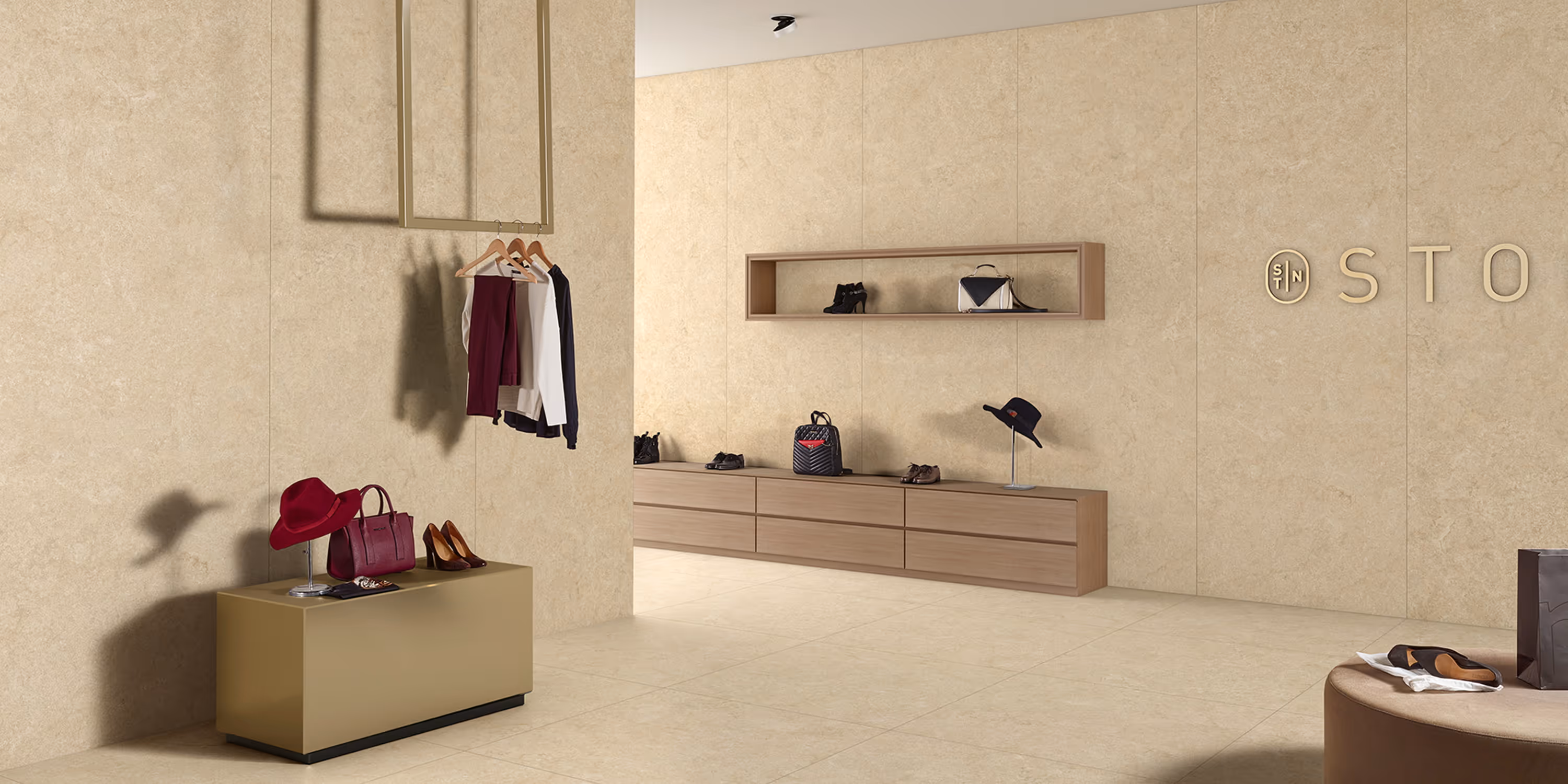 Minimalist fashion store interior with beige stone walls, handbags, shoes, and clothing displays.