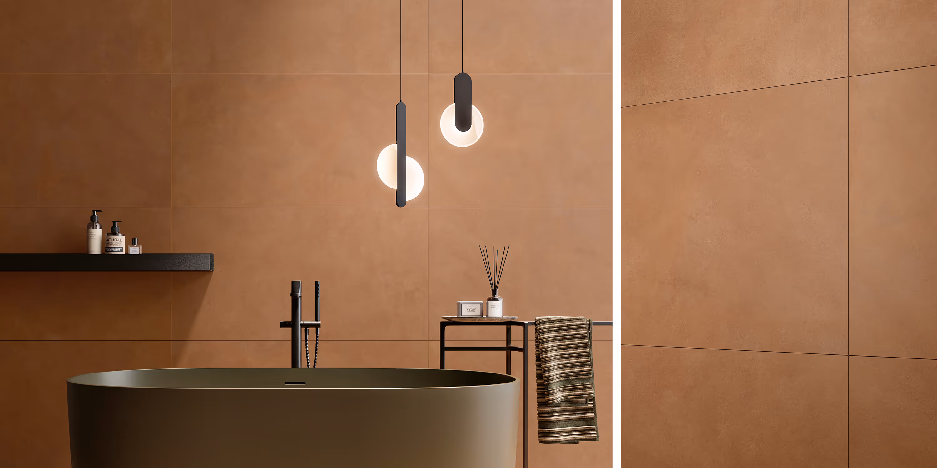 Modern bathroom with olive green freestanding tub, black fixtures, beige wall tiles, and hanging pendant lights.