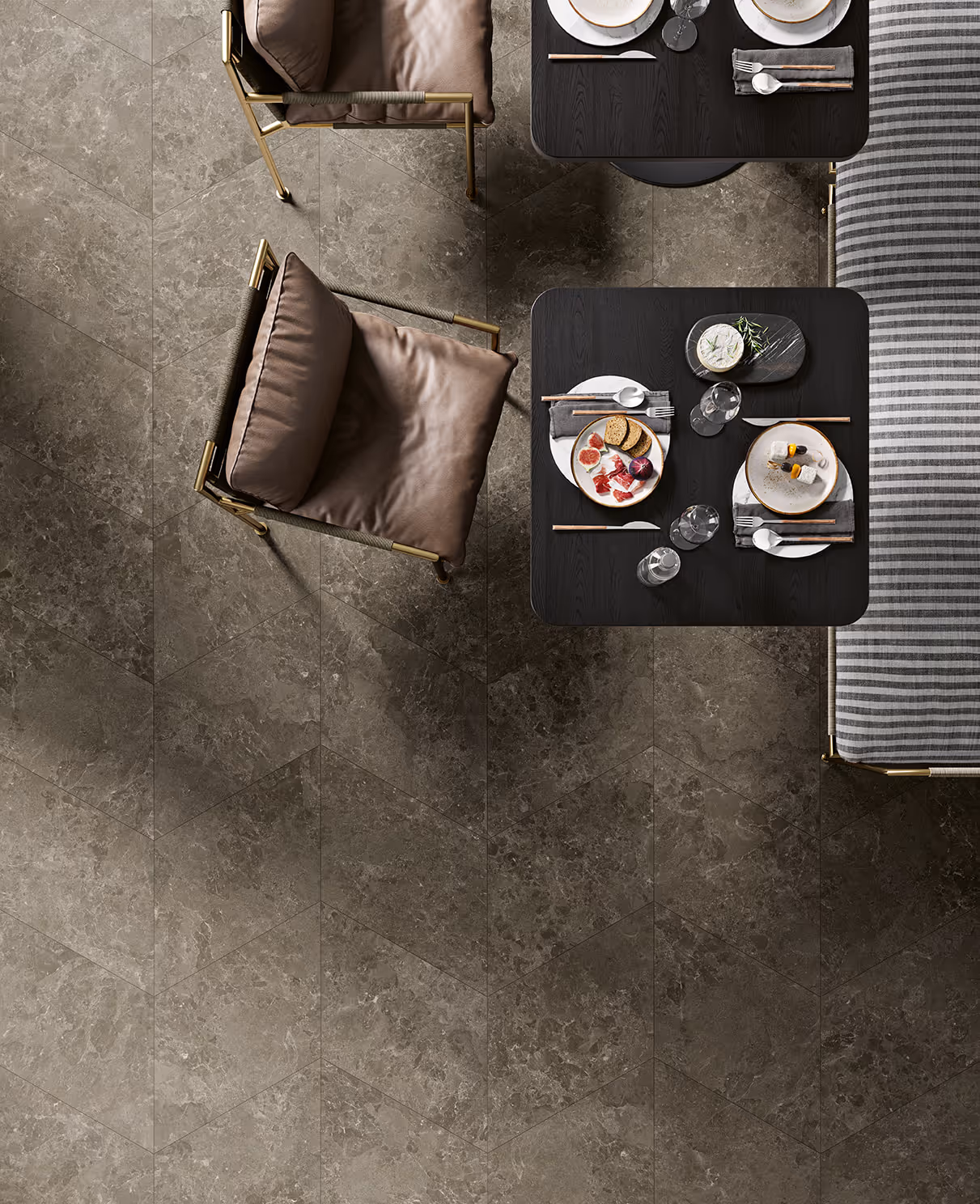 Top view of dining table with plates, cutlery, cushioned chairs, and stone tile floor in chevron pattern.