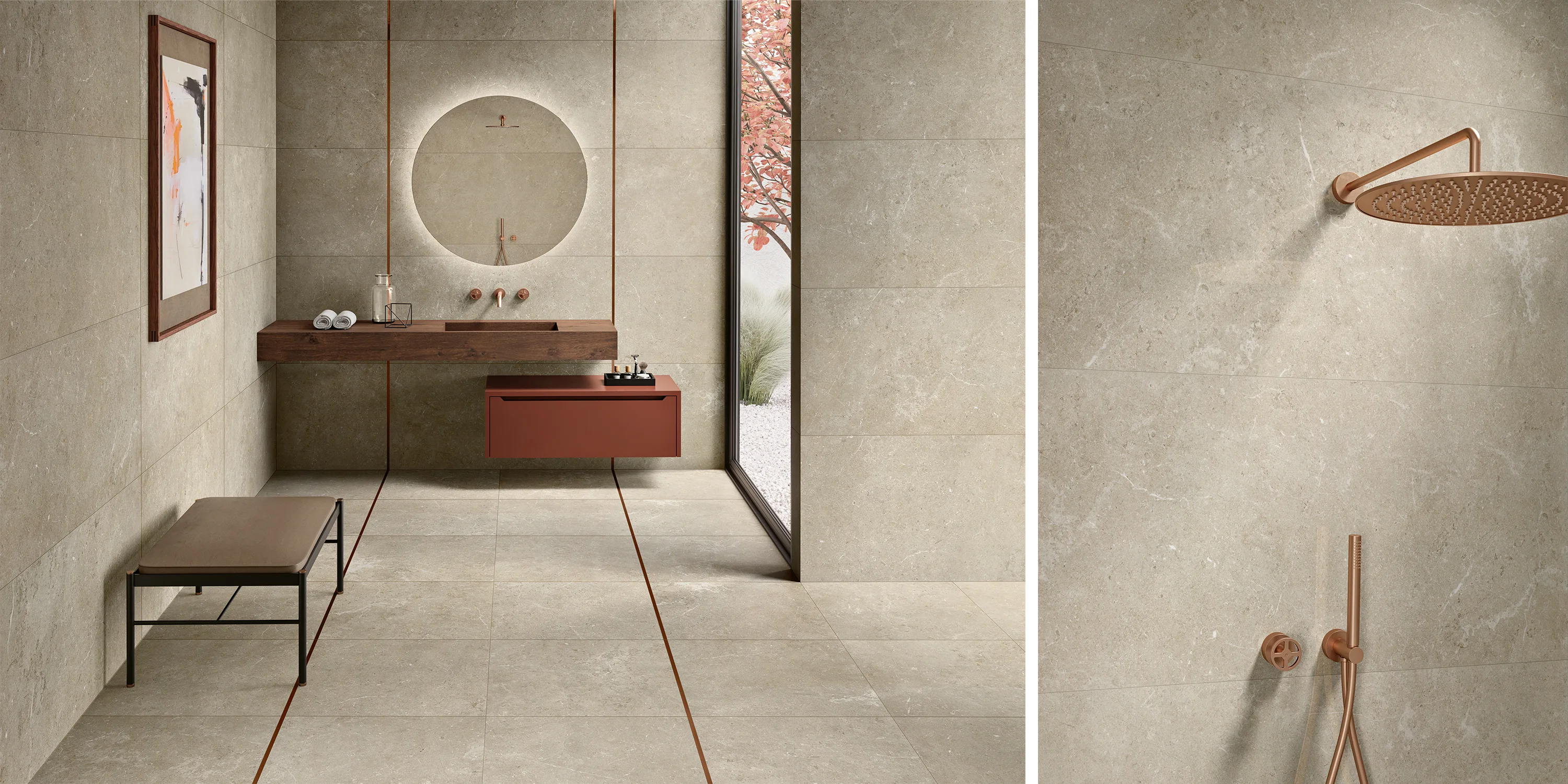 Modern bathroom with beige stone tiles, round illuminated mirror, brown sink, bench, and copper shower fixtures.