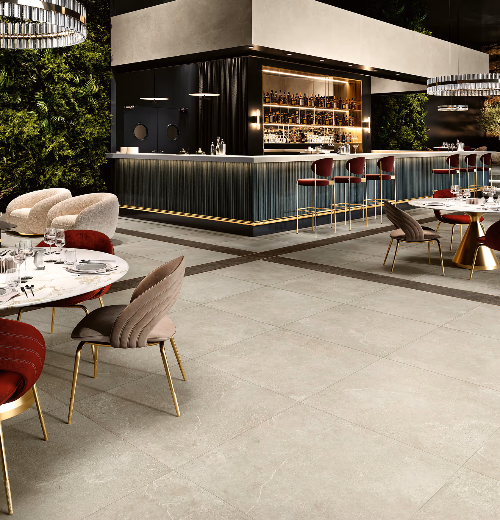 Modern bar area in restaurant with gray tile flooring, gold-accented furniture, and green plant walls.