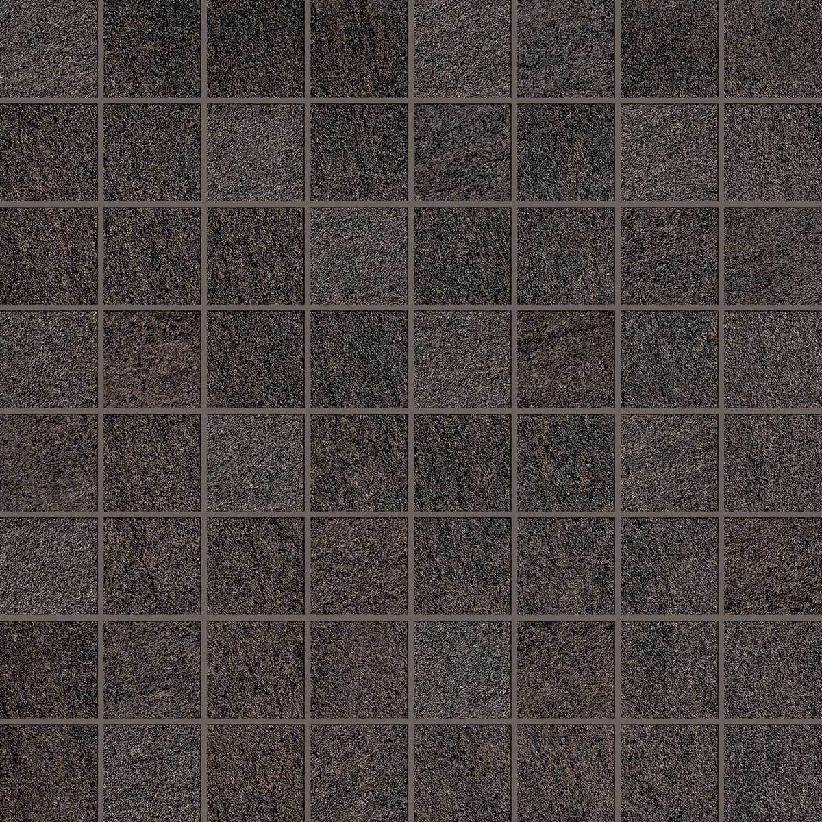 Grid of dark textured square tiles arranged in a mosaic pattern with gray grout lines.