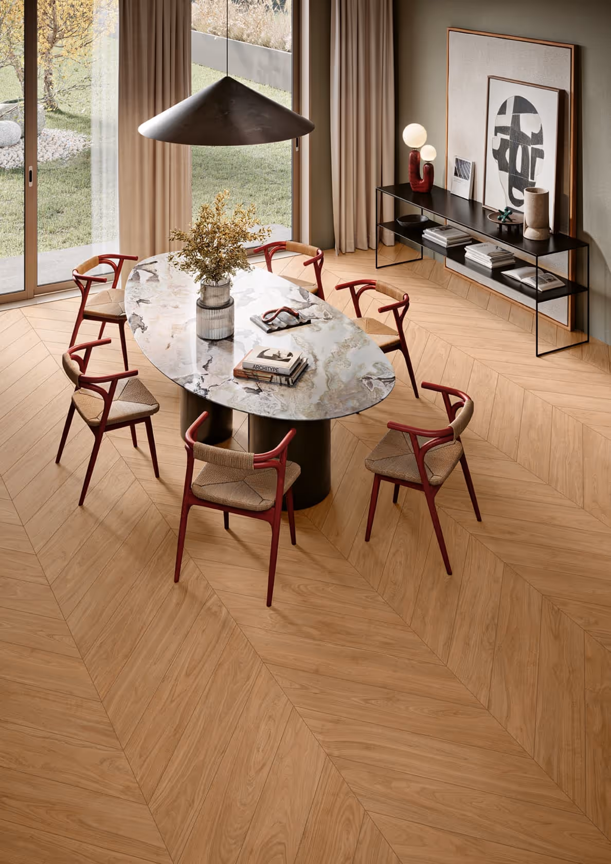 Modern dining room with an oval marble table, six red wooden chairs, and a pendant light.