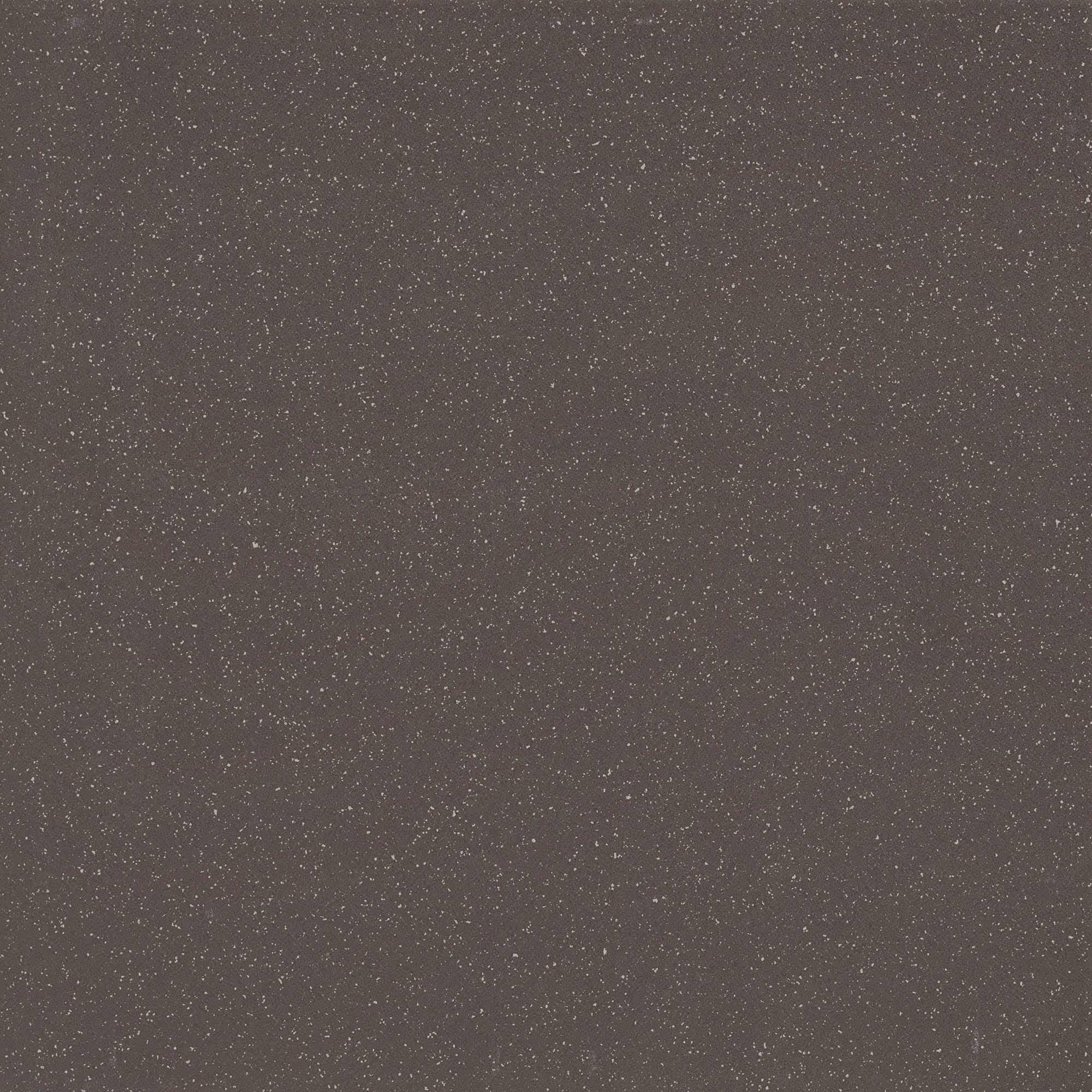 Black textured surface with fine white speckles scattered evenly across it.