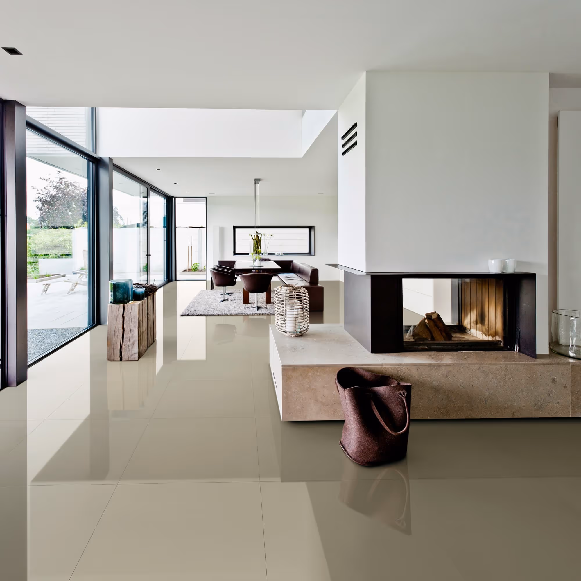 Modern living area with large windows, glossy floor, fireplace, dining table, and decorative items.
