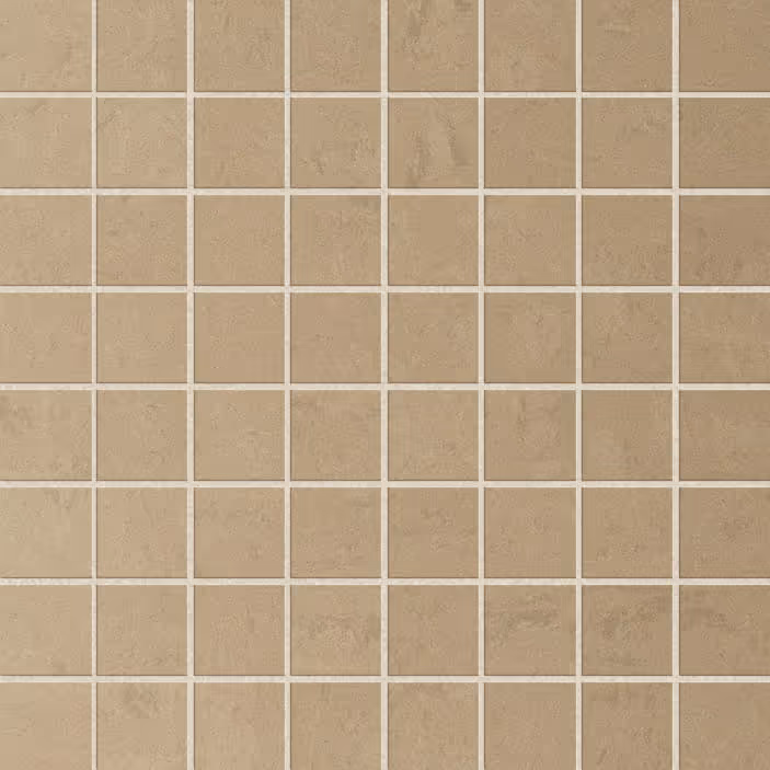 Beige mosaic wall tiles in a grid pattern with grout lines between square tiles.