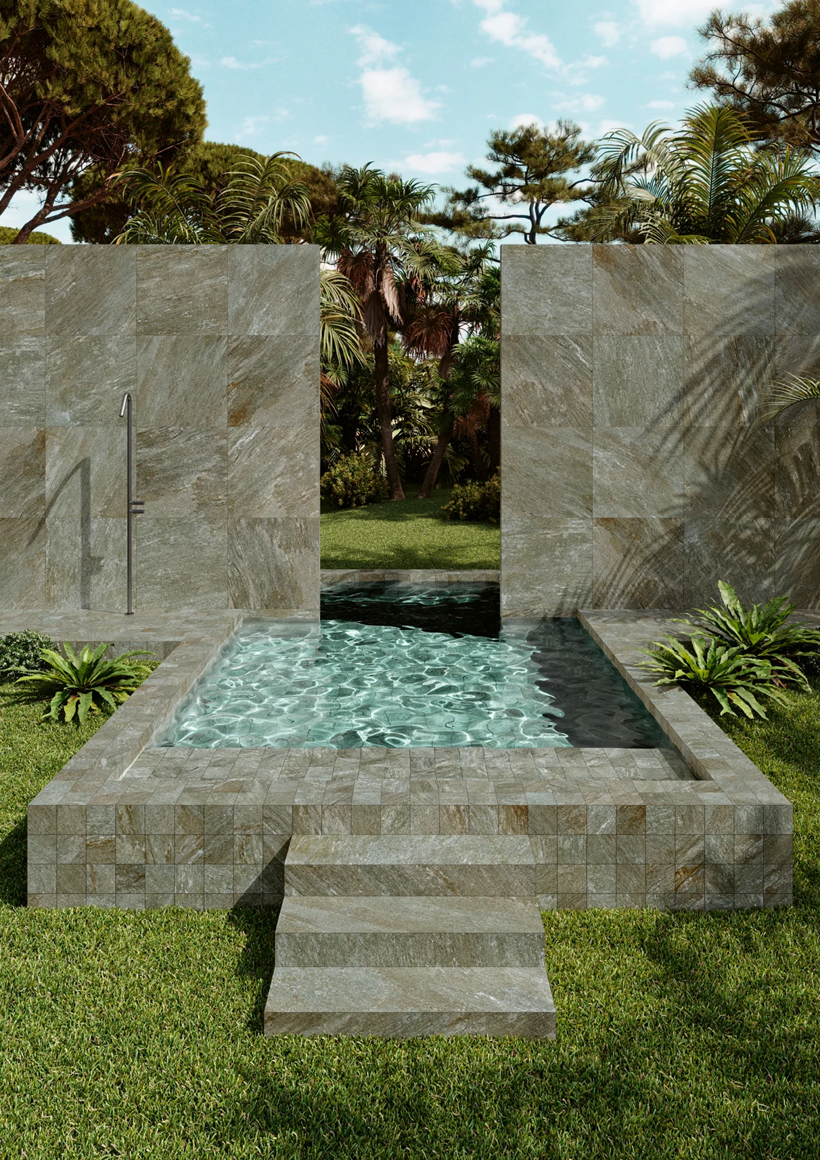 Small rectangular stone pool with clear water set in a grassy garden surrounded by trees and plants.
