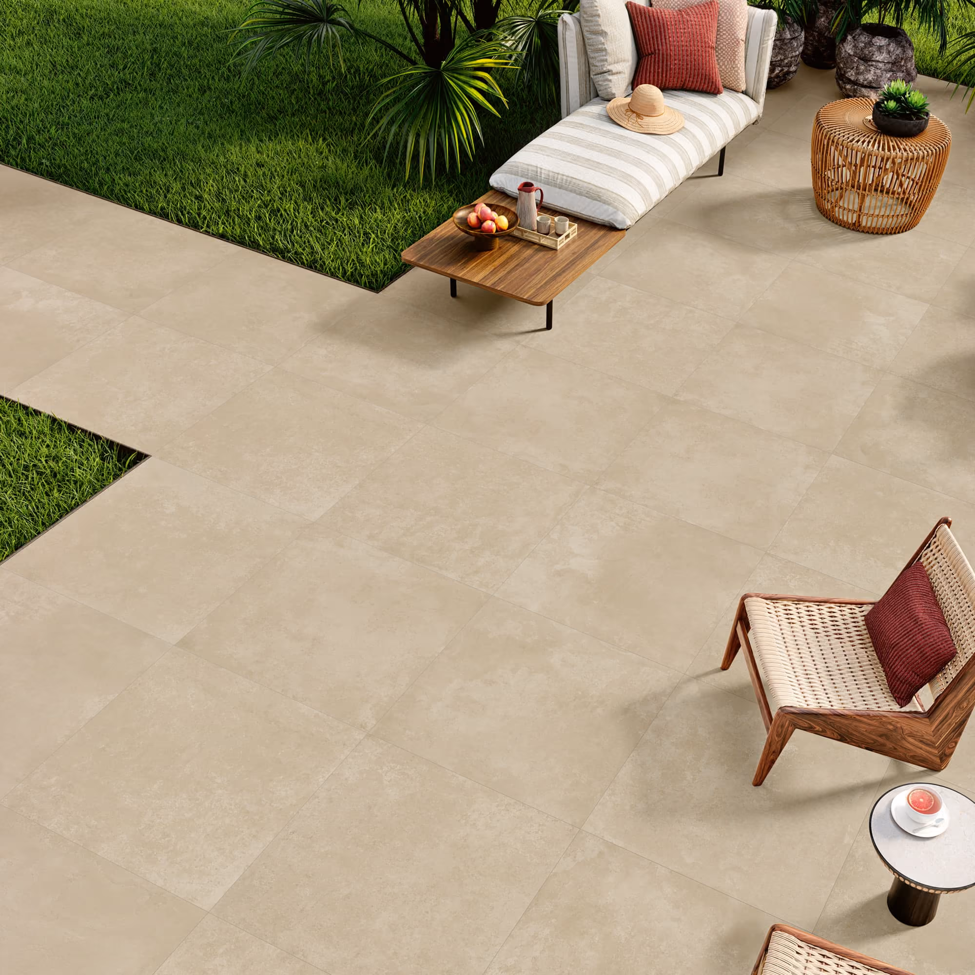 Outdoor patio with beige tile flooring, lounge chair, wicker chair, wooden table, and green plants.