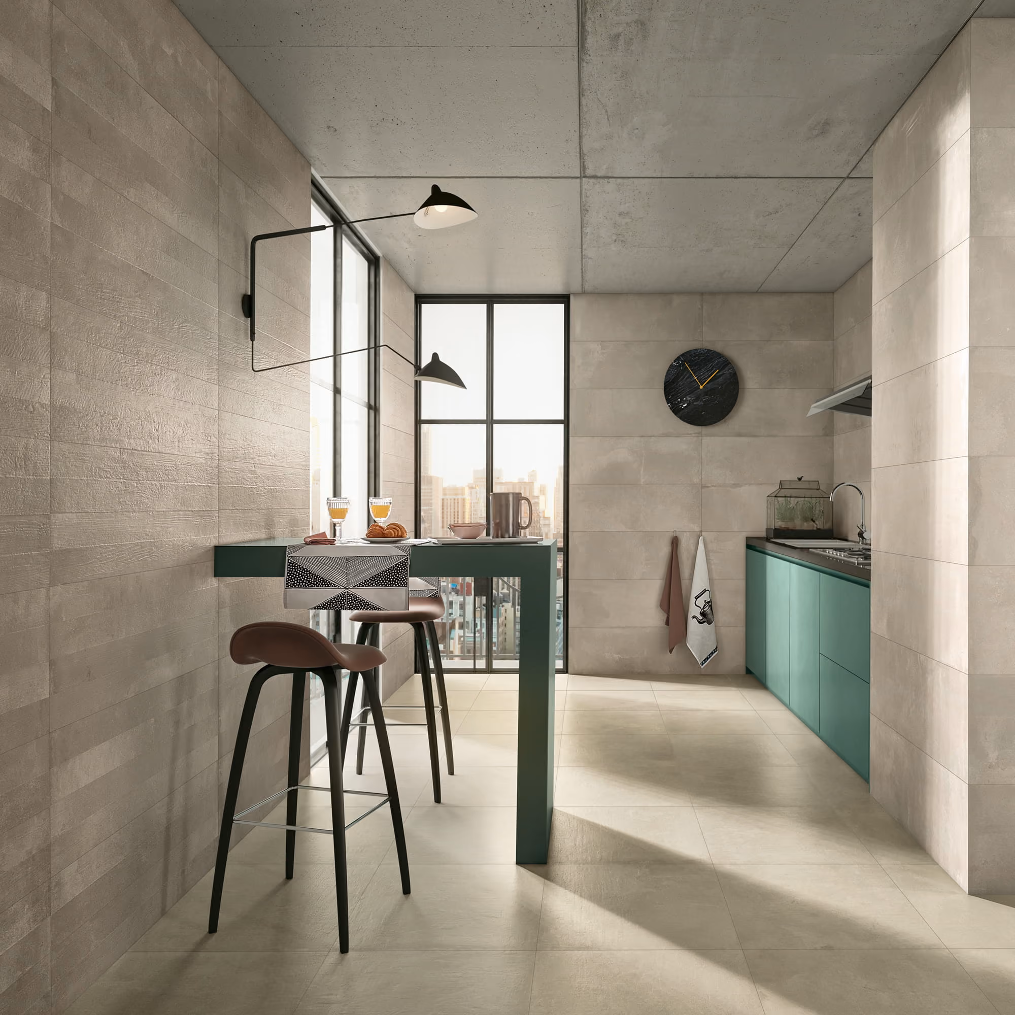 Modern kitchen with green cabinets, high table with stools, and large windows overlooking city buildings.