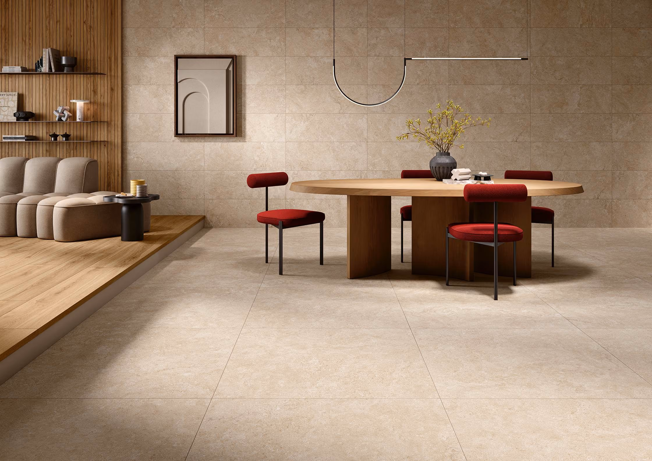 Modern dining area with round wooden table, red chairs, beige tiled floor, and a cozy beige couch on wood floor.