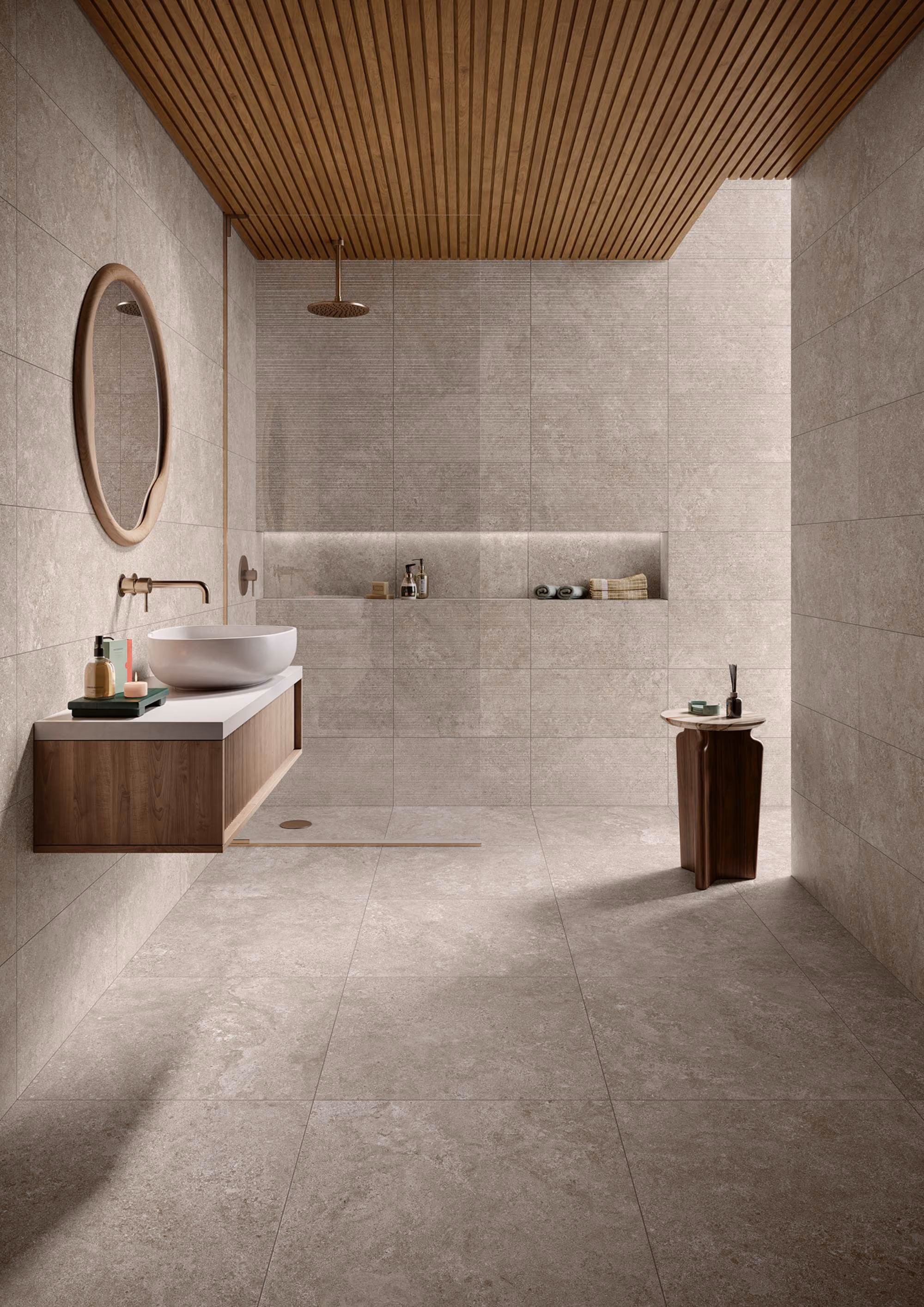 Minimalist bathroom with beige tiles, wooden ceiling, round mirror, floating sink, and a walk-in shower.