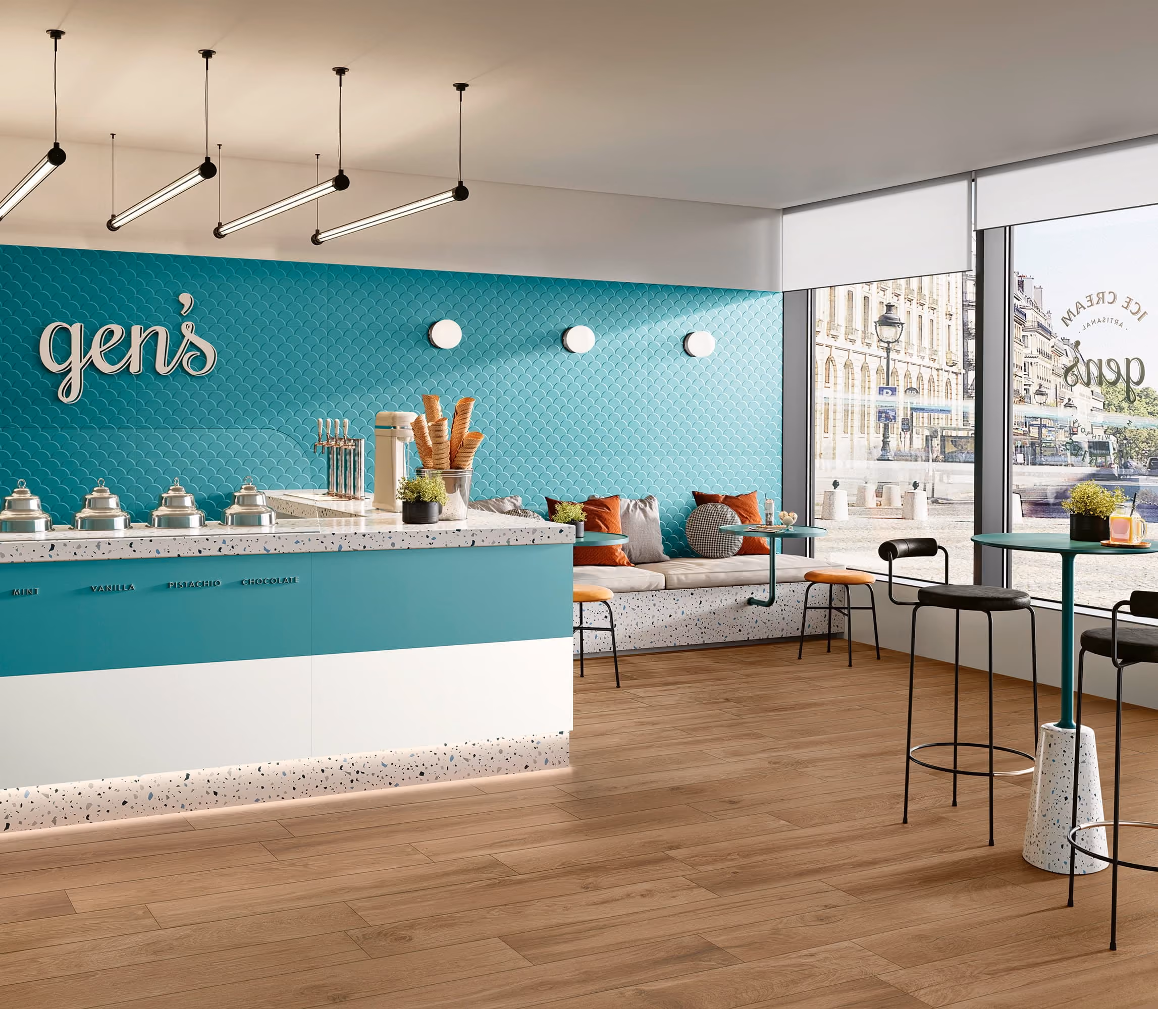 Modern ice cream shop interior with teal counter, waffle cones, seating, and large windows.