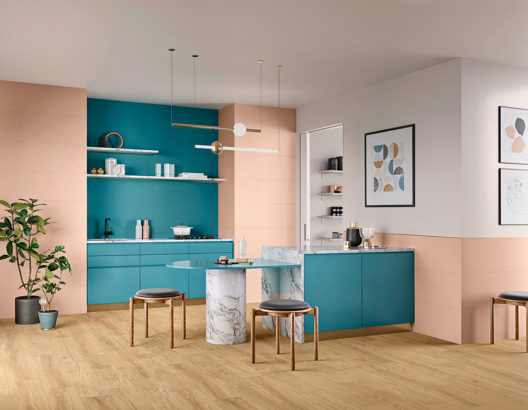 Modern kitchen with teal cabinets, marble island, light wood floor, pink walls, stools, and pendant lights.