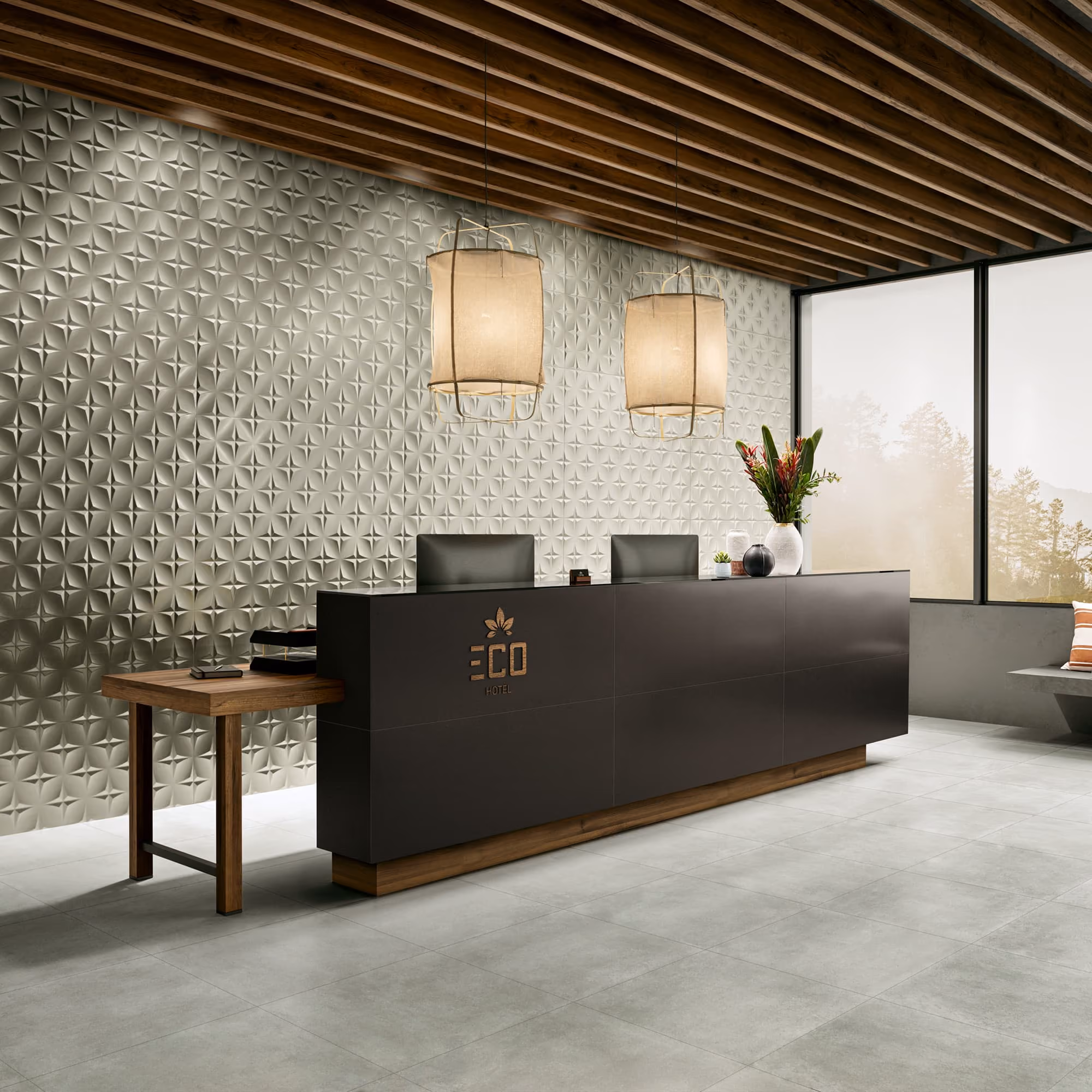Modern hotel reception desk with two black chairs, pendant lights, and decorative wall panels.
