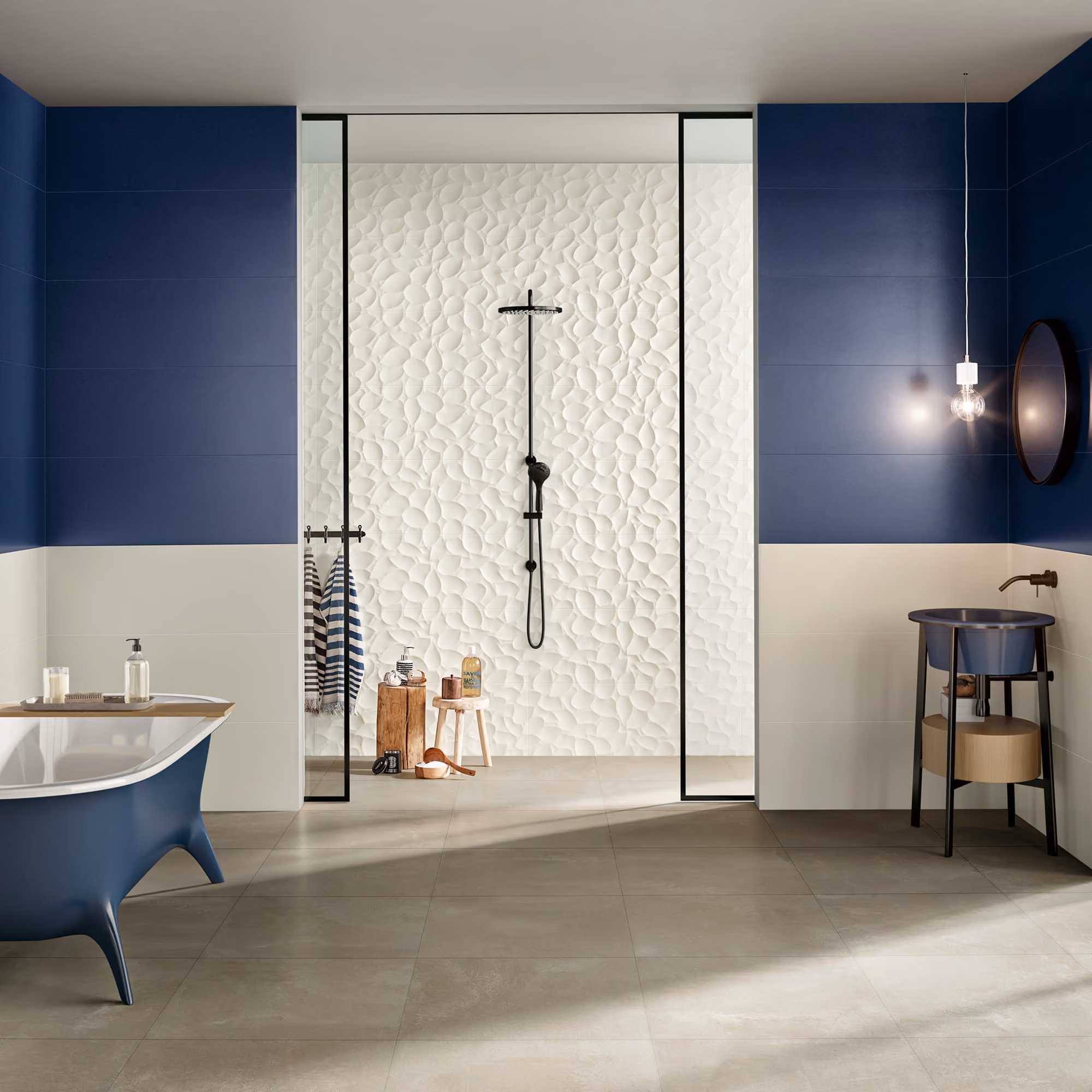 Modern bathroom with blue and white walls, a freestanding tub, and a textured white shower wall.