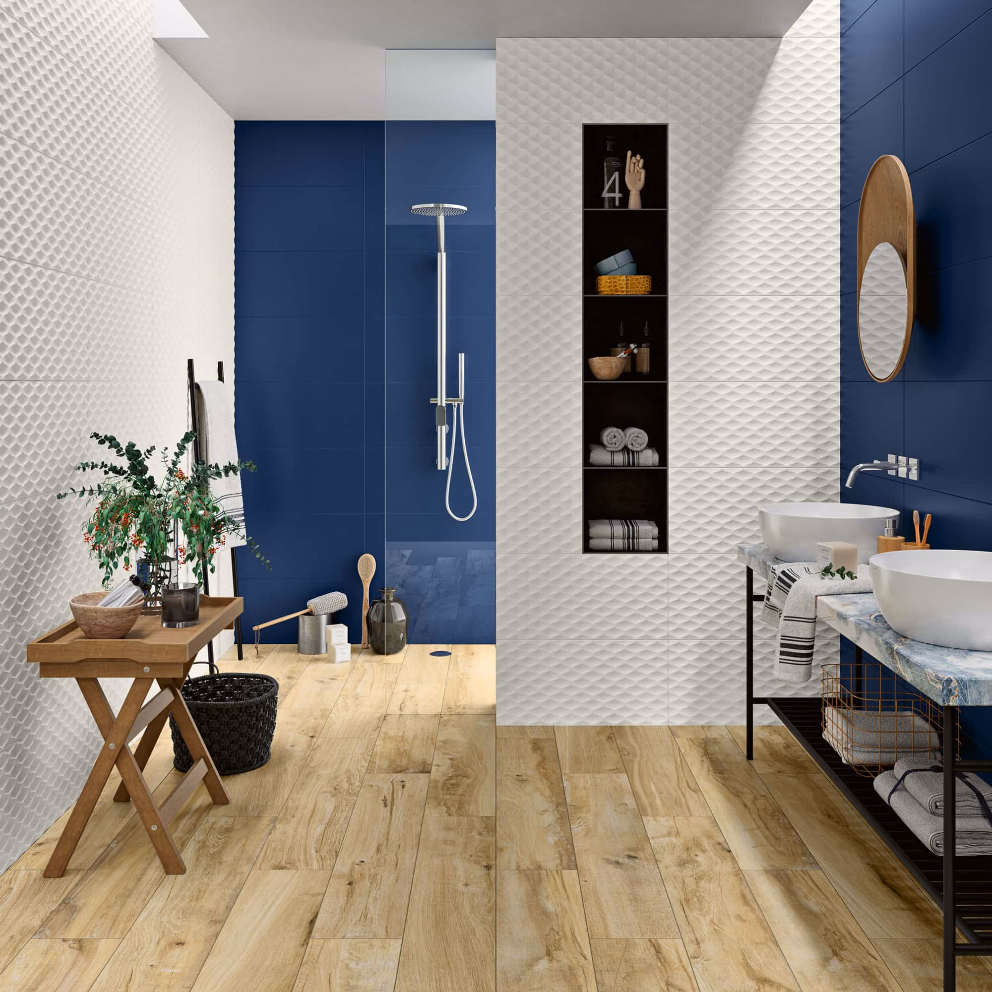 Modern bathroom with blue and white textured walls, wooden floor, double sinks, and glass shower.