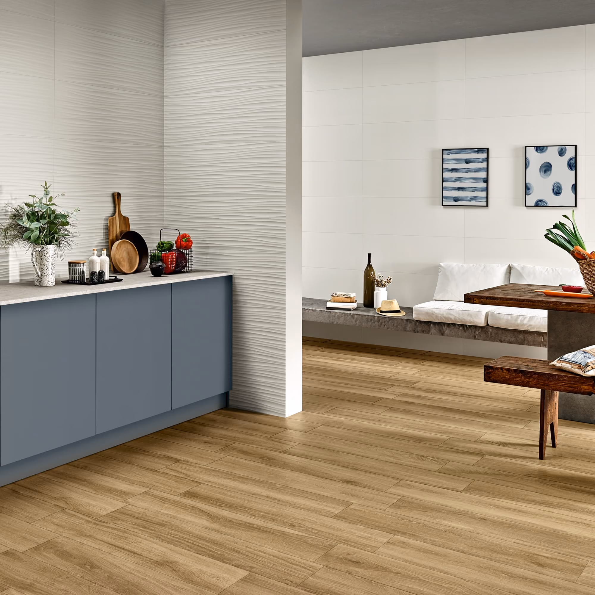 Modern kitchen and seating area with blue cabinets, wood floor, textured wall, and decorative plants.
