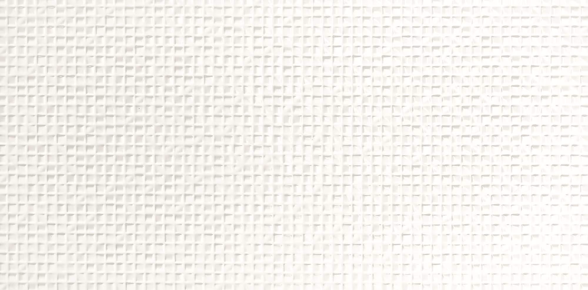 Close-up of a white textured surface with a small square grid pattern.