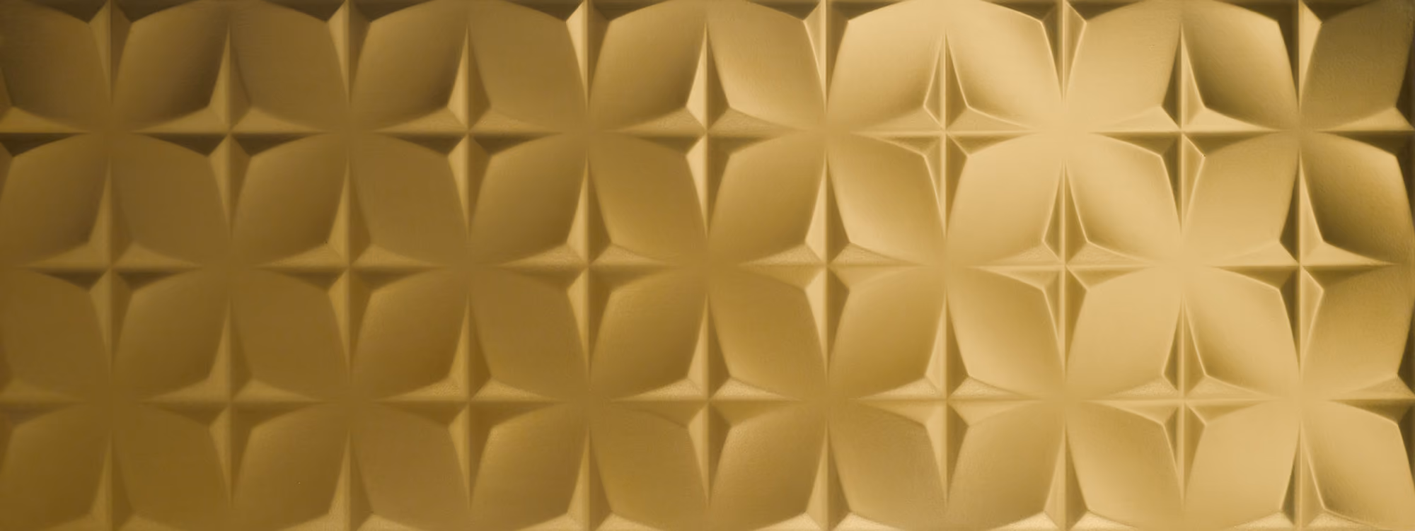 Gold textured surface with repeating geometric star-like 3D pattern.
