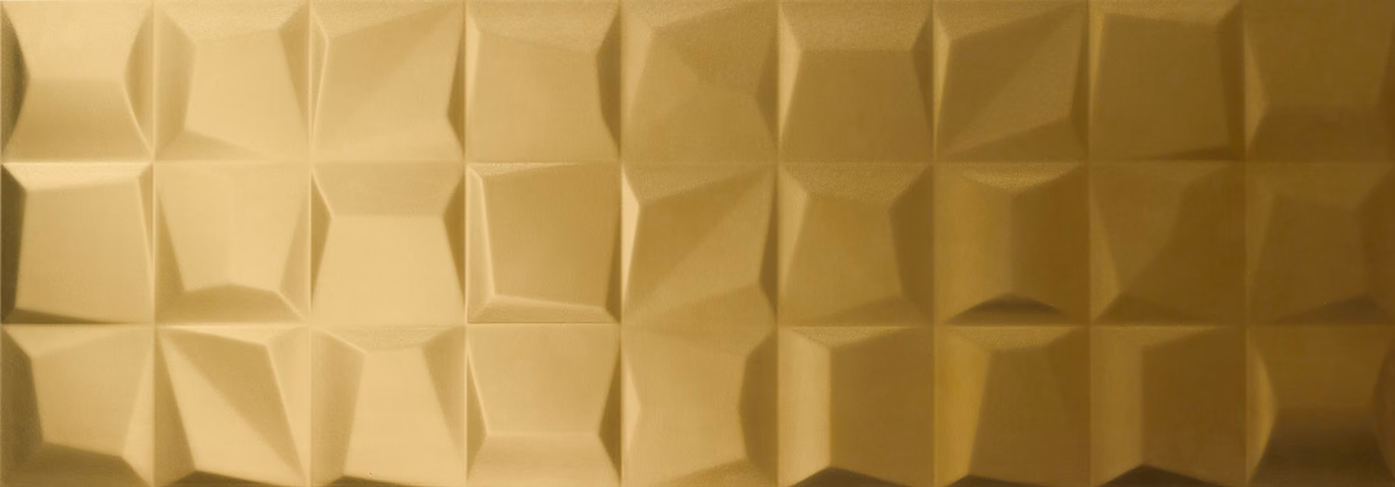 Gold textured surface with a pattern of irregular, faceted square tiles.
