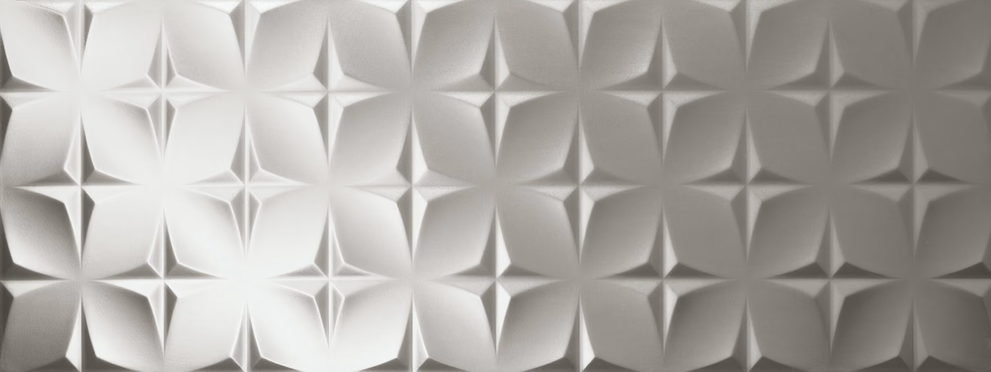Silver geometric textured panel with a repeating pattern of star-like shapes and diamond forms.