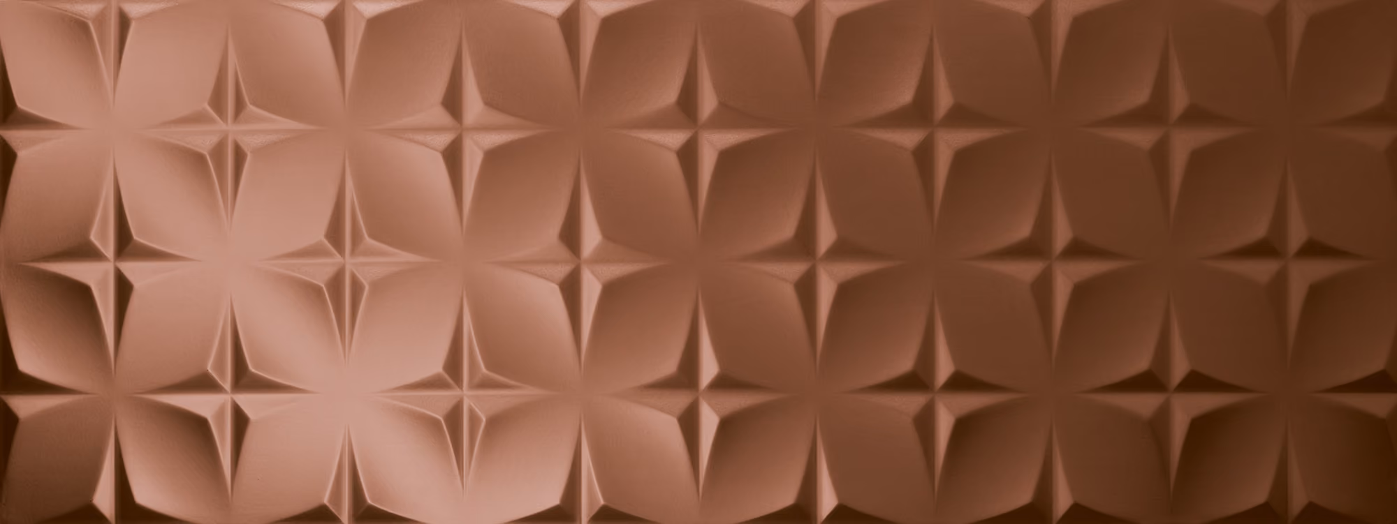 Geometric patterned surface with repeating four-petal flower shapes in copper tones.