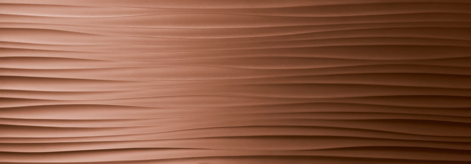 Close-up of a copper surface with a textured, wavy horizontal pattern.