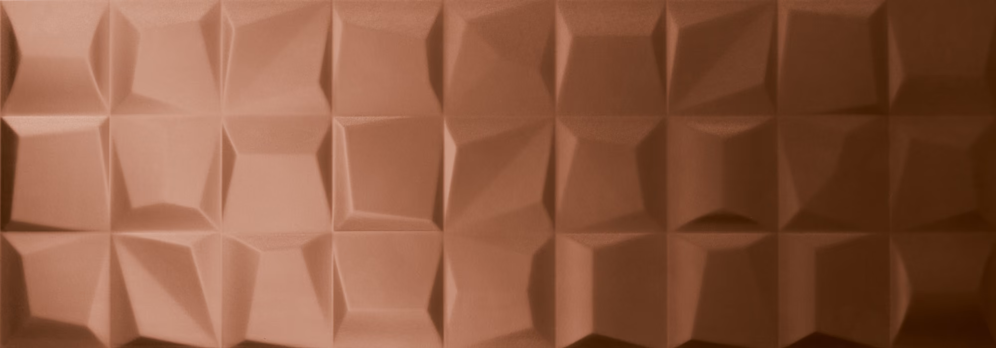 Copper-toned 3D geometric patterned wall with faceted rectangular shapes.