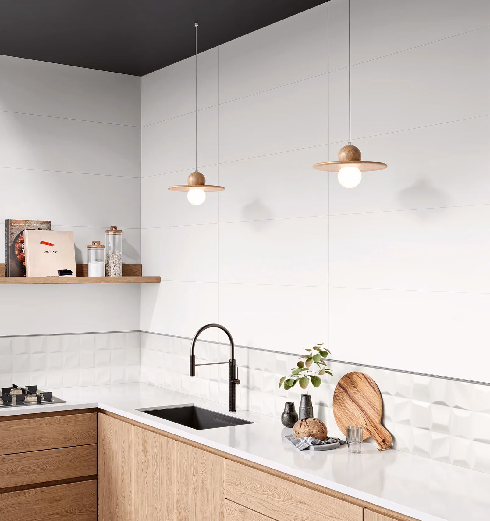 Modern kitchen corner with wooden cabinets, black sink and faucet, white backsplash, and two hanging pendant lights.