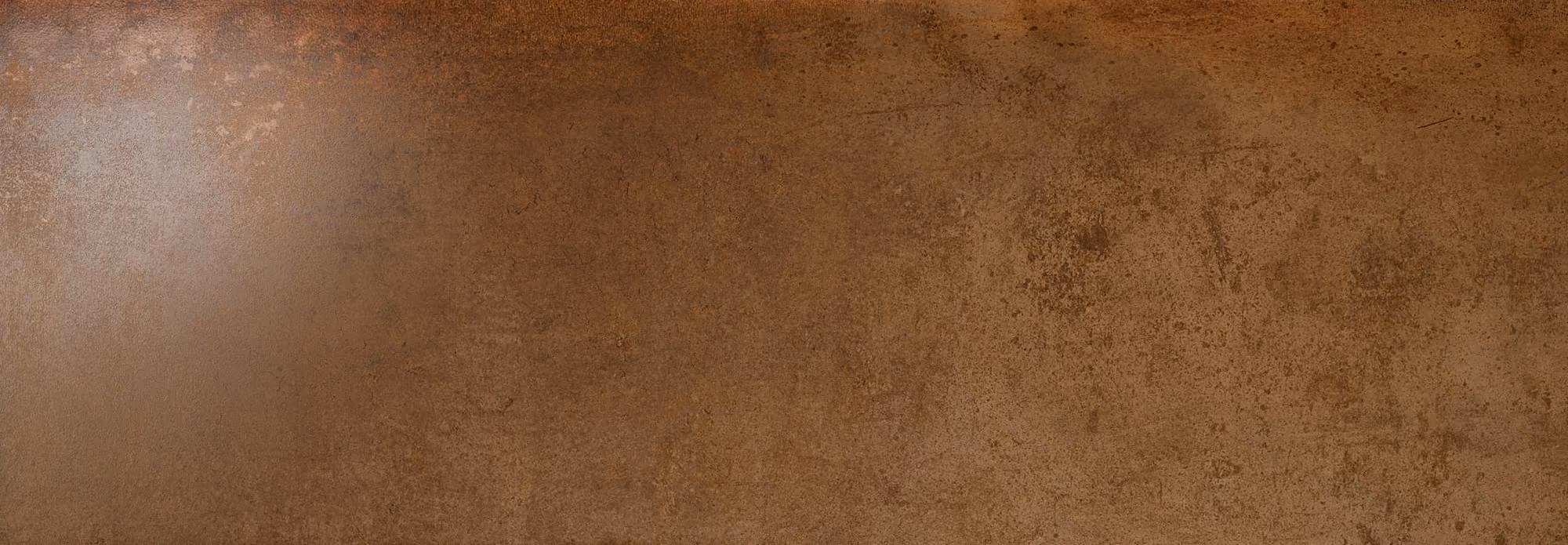 Rust-colored metallic surface with textured, weathered and corroded appearance.