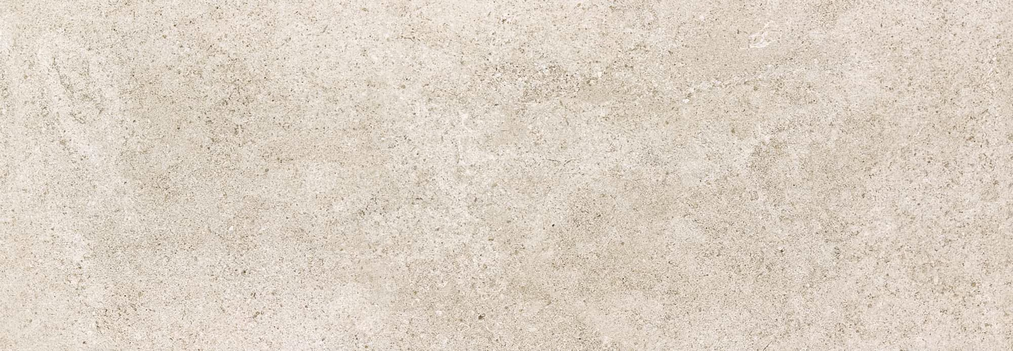 Close-up of light gray textured concrete surface with slight speckles.