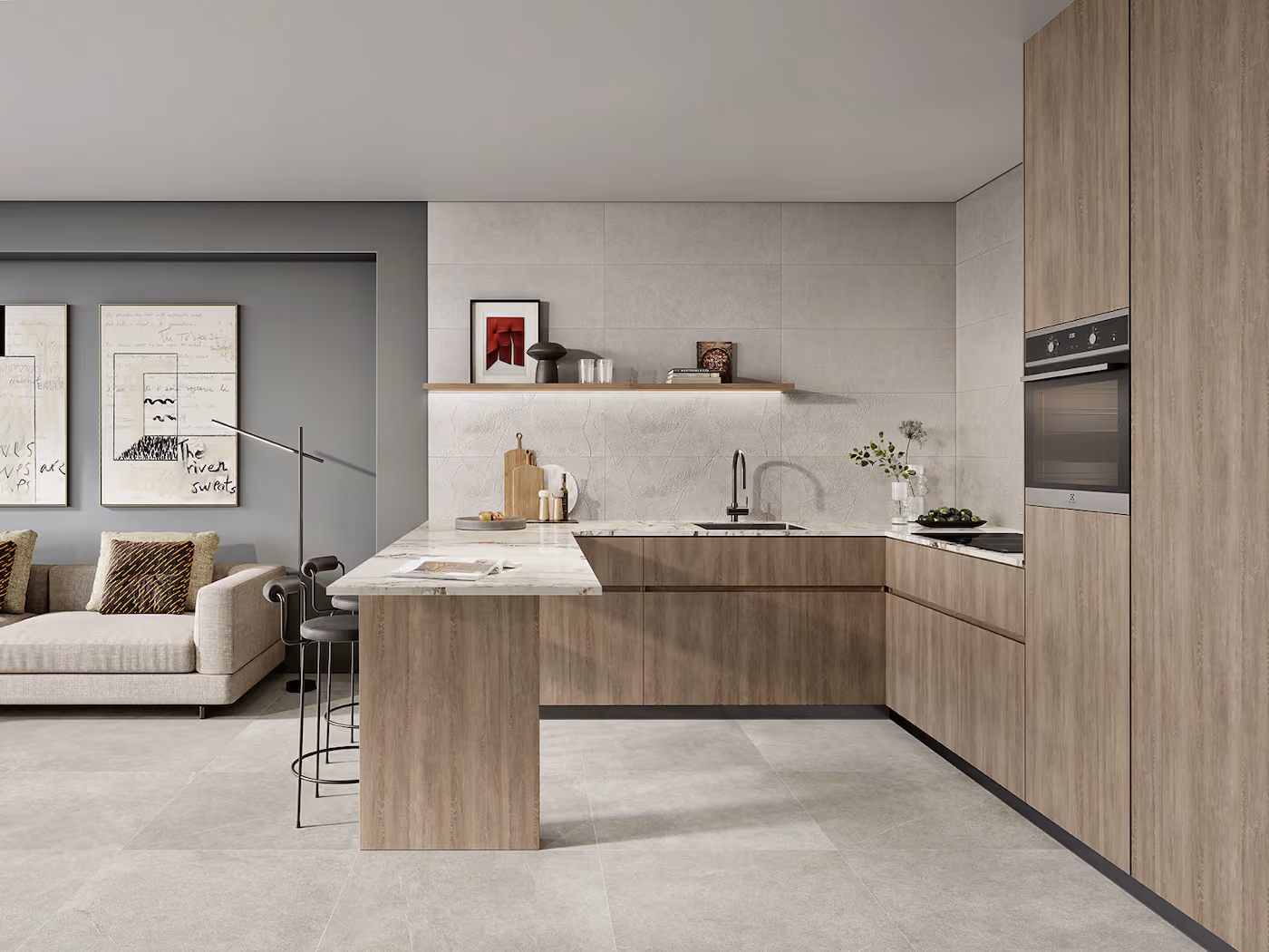 Modern kitchen with wood cabinets, marble countertop, built-in oven, and a beige sofa with wall art in background.
