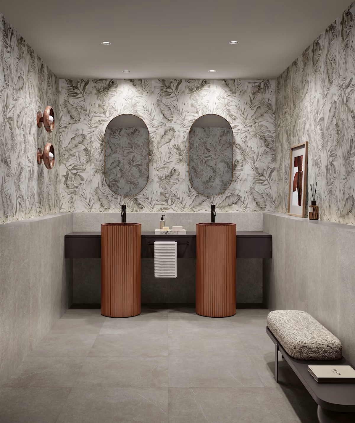 Modern bathroom with leaf-patterned walls, two oval mirrors, brown cylindrical sinks, and a bench with cushion.