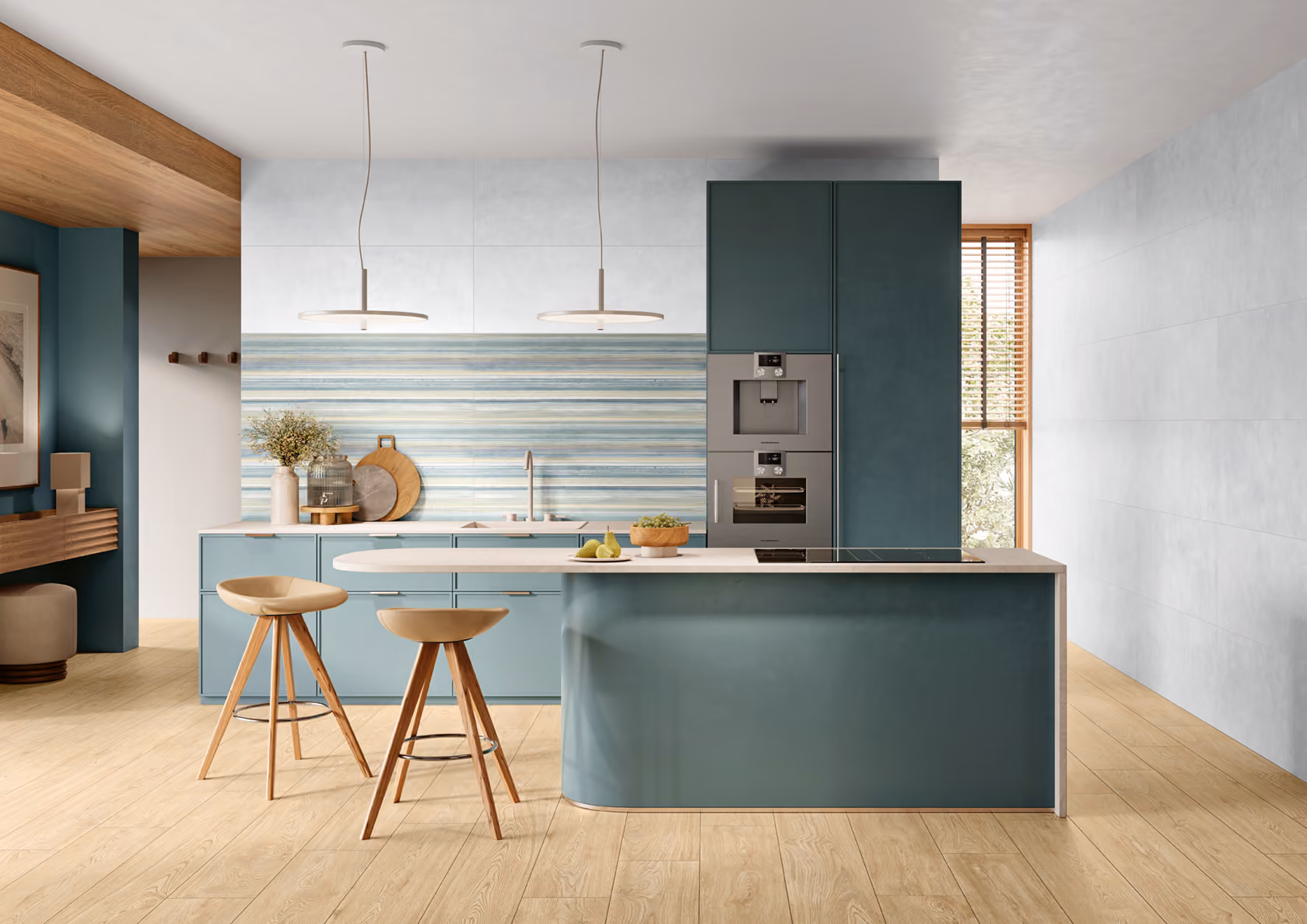 Modern kitchen with teal cabinets, island, two wooden stools, and striped backsplash under pendant lights.
