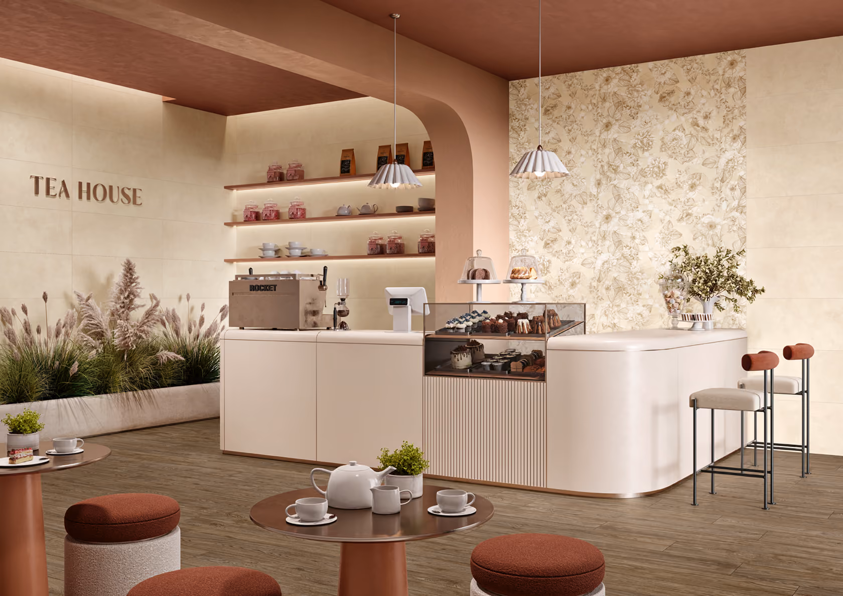 Modern tea house interior with a counter displaying cakes, shelves with jars, and seating with tables and stools.