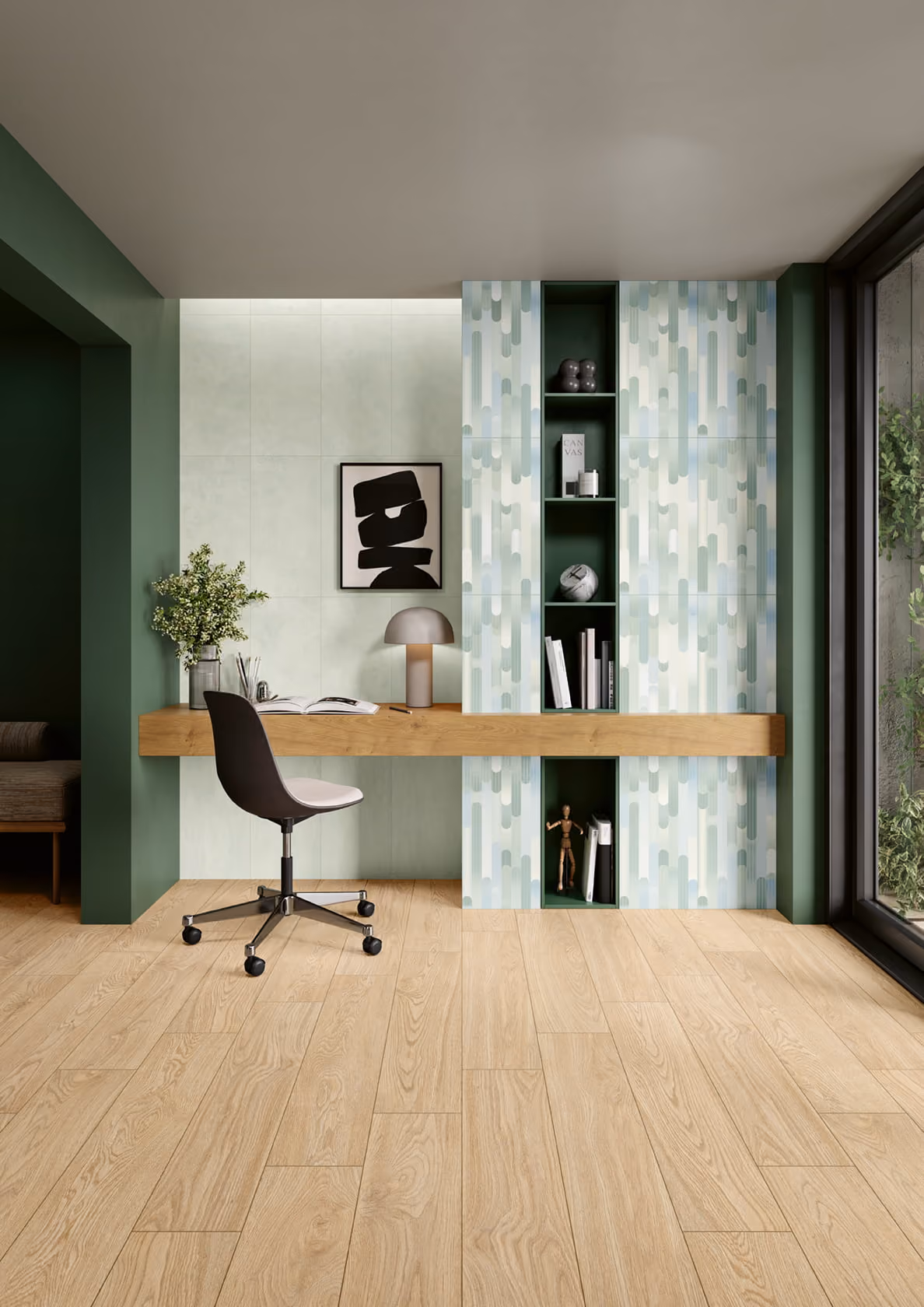 Modern workspace with wooden desk, black swivel chair, lamp, abstract art, and built-in shelves with decor.