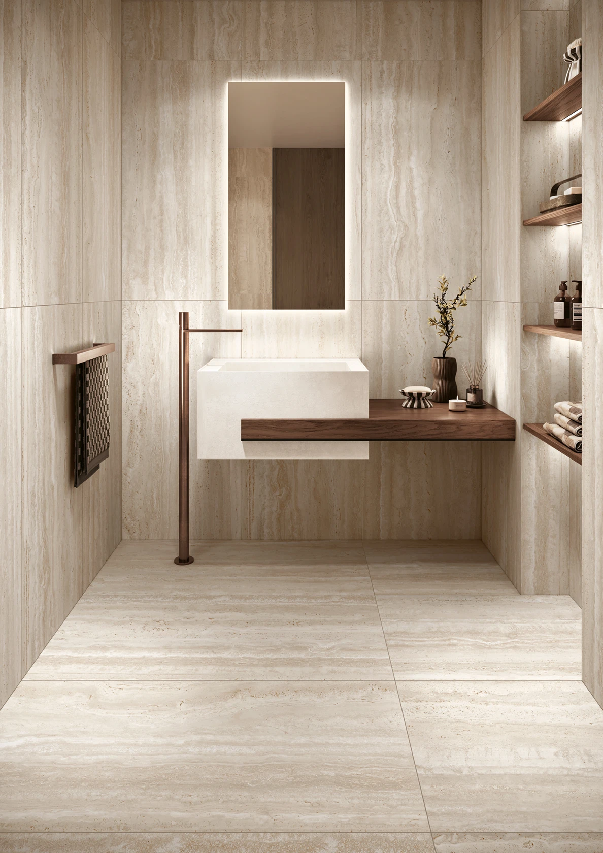 Minimalist bathroom with a floating white sink, wooden counter, backlit mirror, and tiled walls and floor.