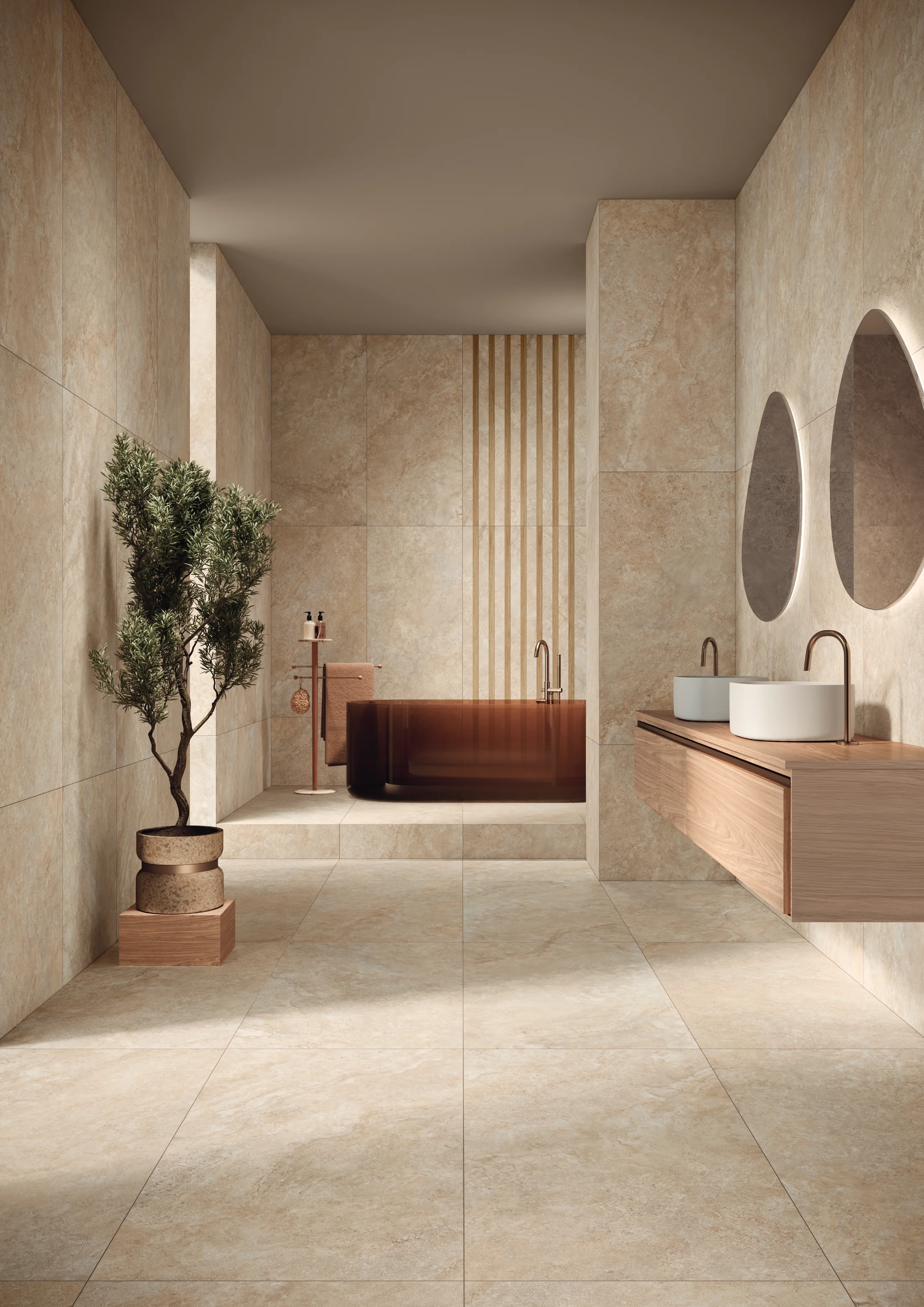 Modern beige bathroom with a brown tub, double round mirrors, two vessel sinks, and a potted plant.