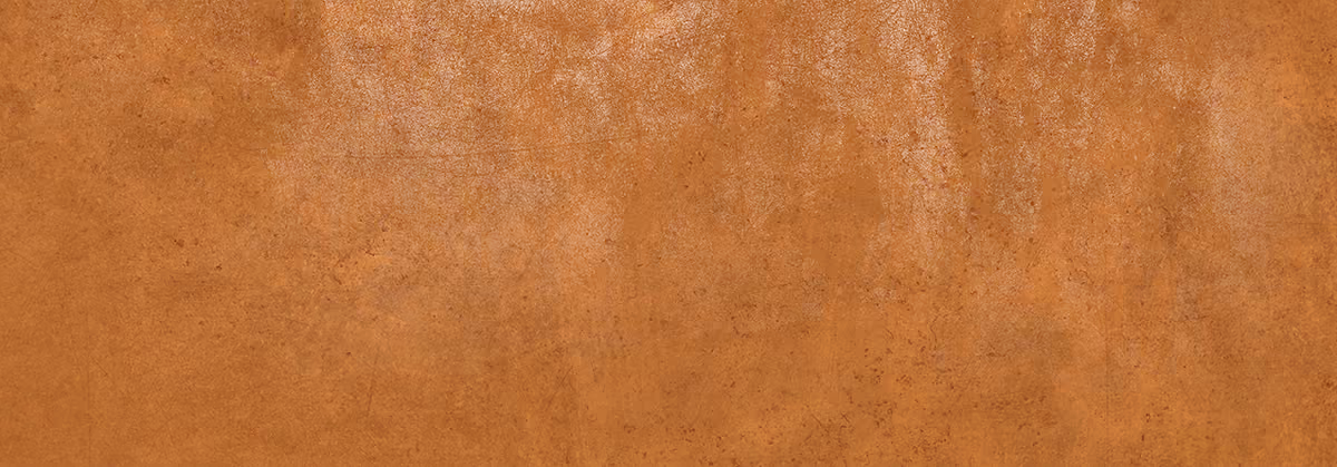 Close-up of a textured, mottled orange surface resembling stained leather or resin.